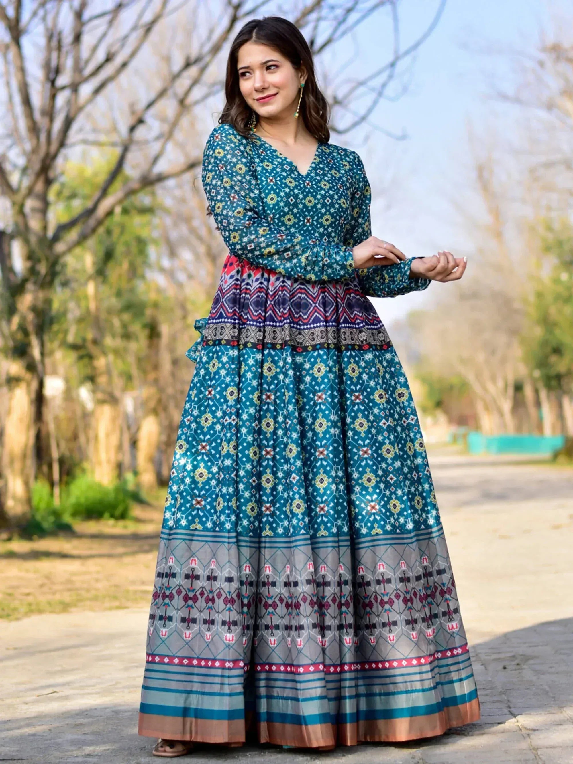 Teal printed ethnic gown with geometric patterns, perfect for Indian festive wear and occasions