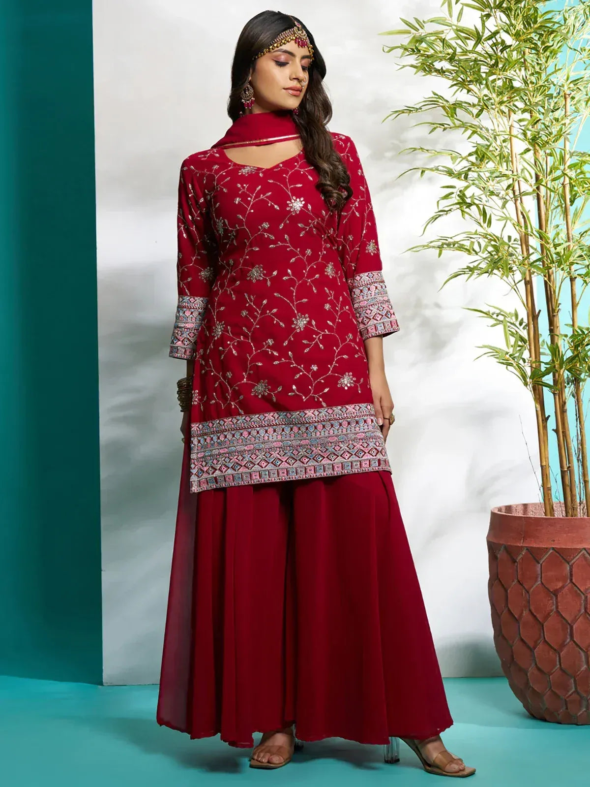Maroon embroidered ethnic salwar kameez with floral thread work and palazzo pants, perfect for Indian occasions.