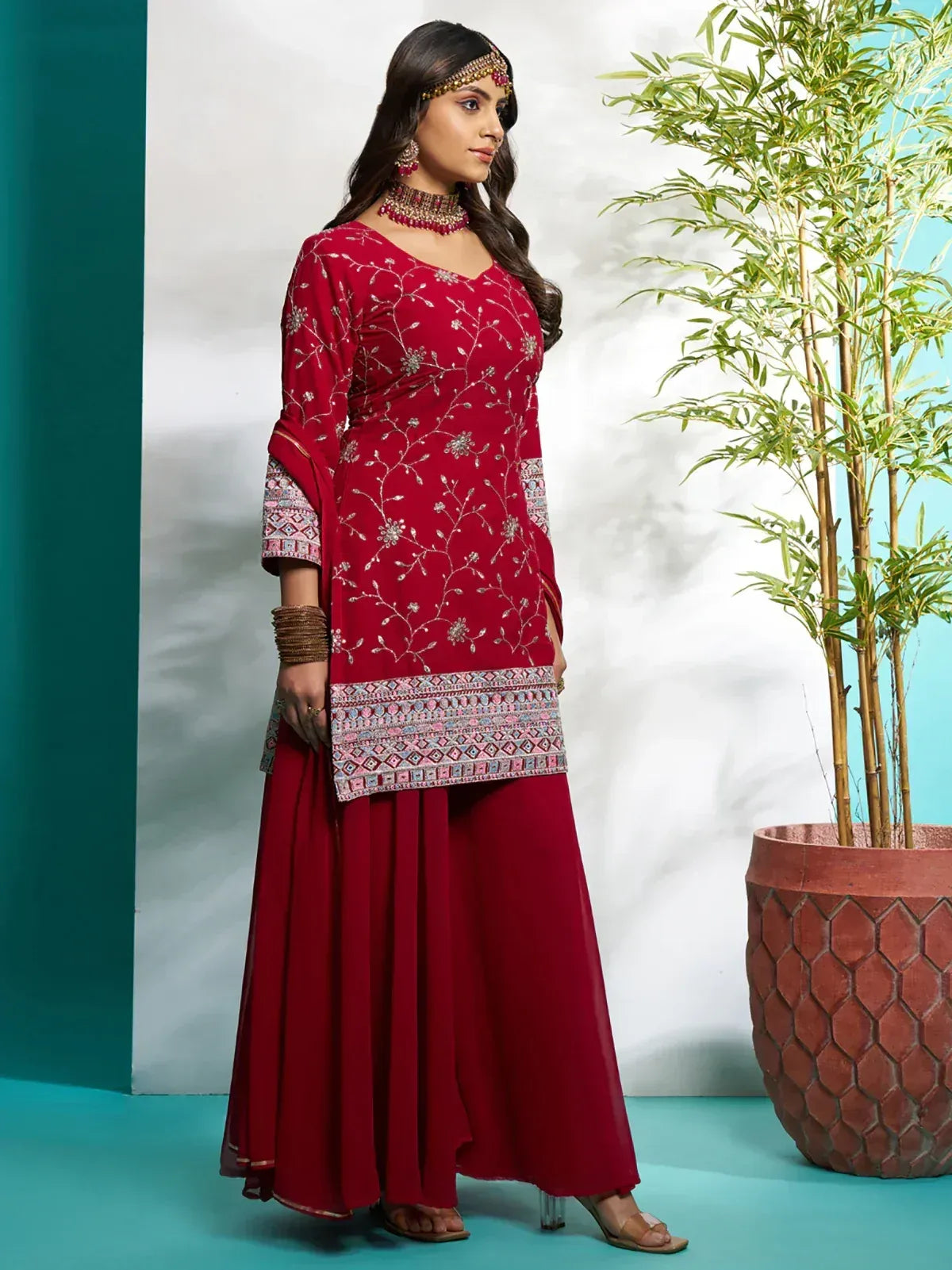 Red embroidered ethnic salwar kameez with floral detailing and dupatta, perfect for festive occasions