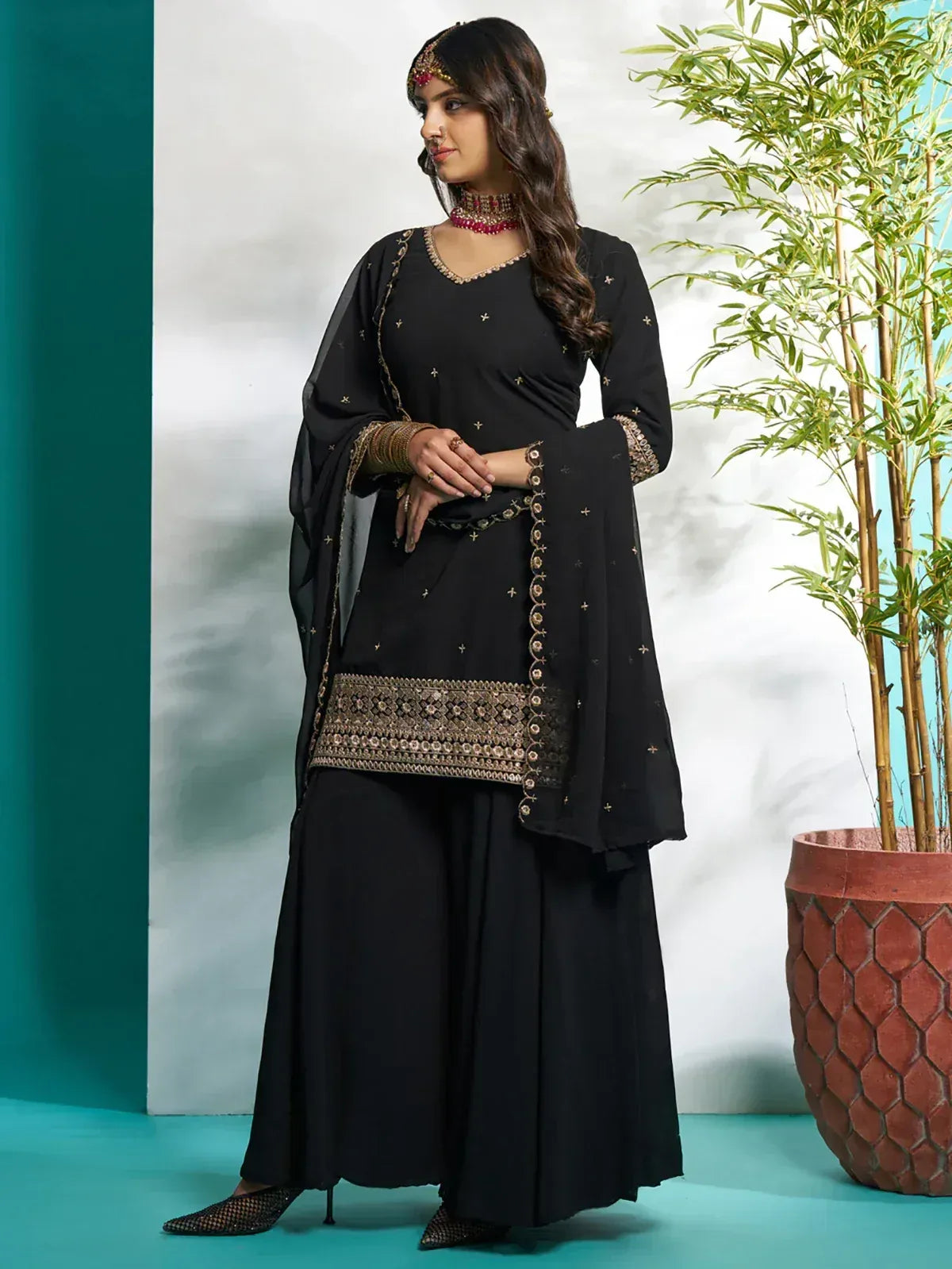 Black embroidered salwar kameez with gold detailing, perfect for Indian ethnic wear occasions