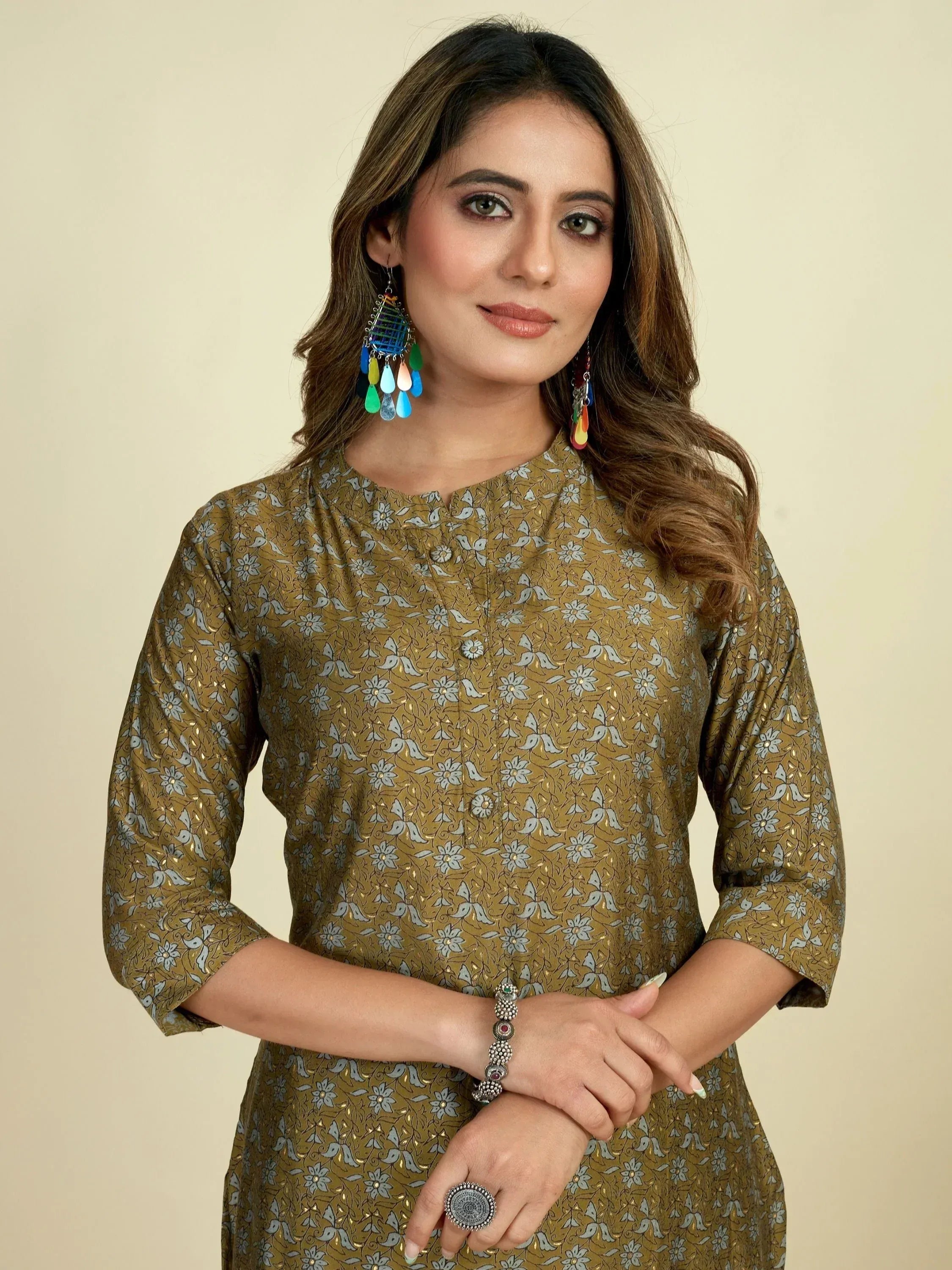 Woman in olive floral printed ethnic kurta with colorful earrings and silver jewelry