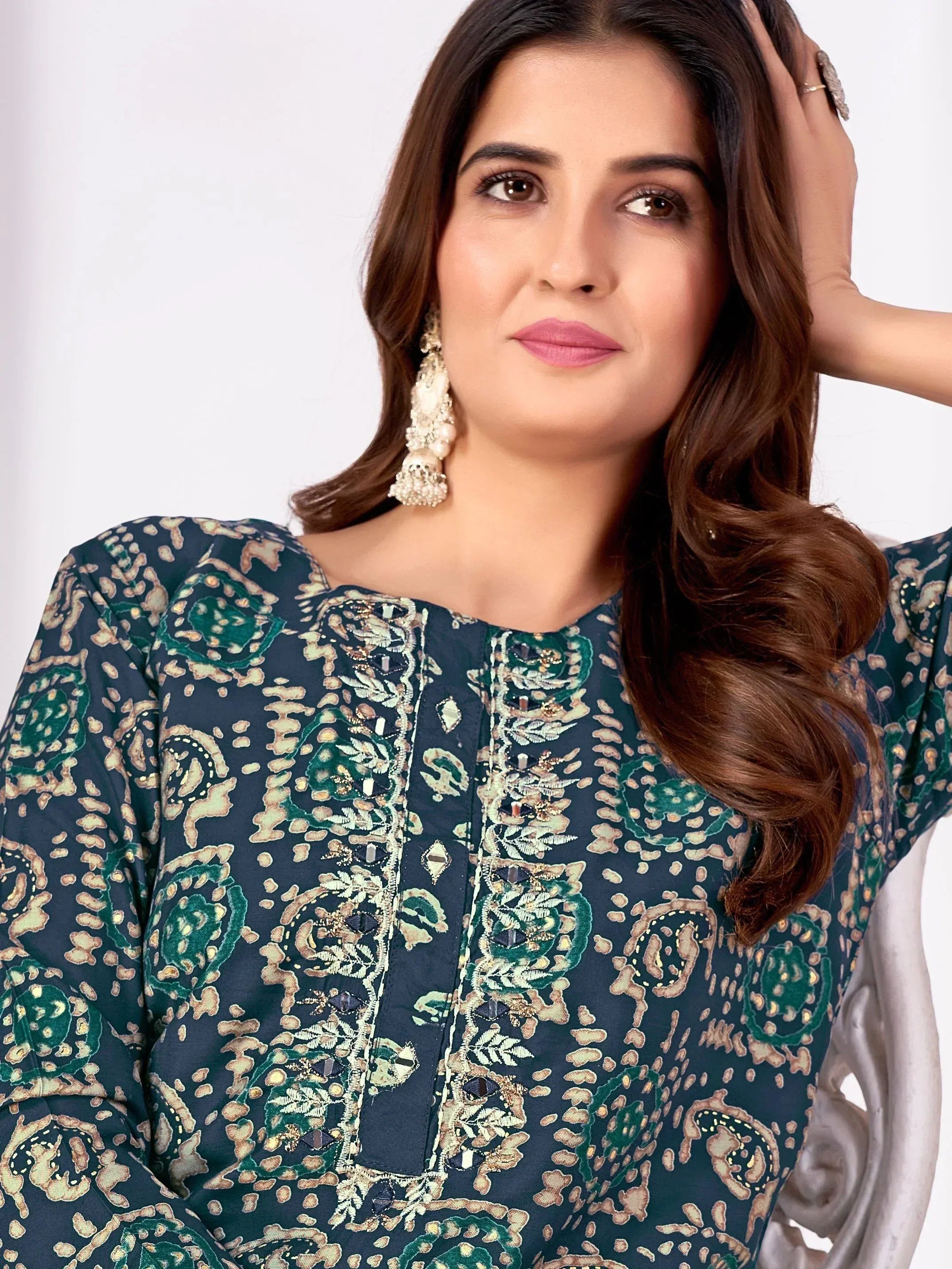 Elegant navy blue printed kurta with green floral embroidery and gold detailing, paired with statement earrings.