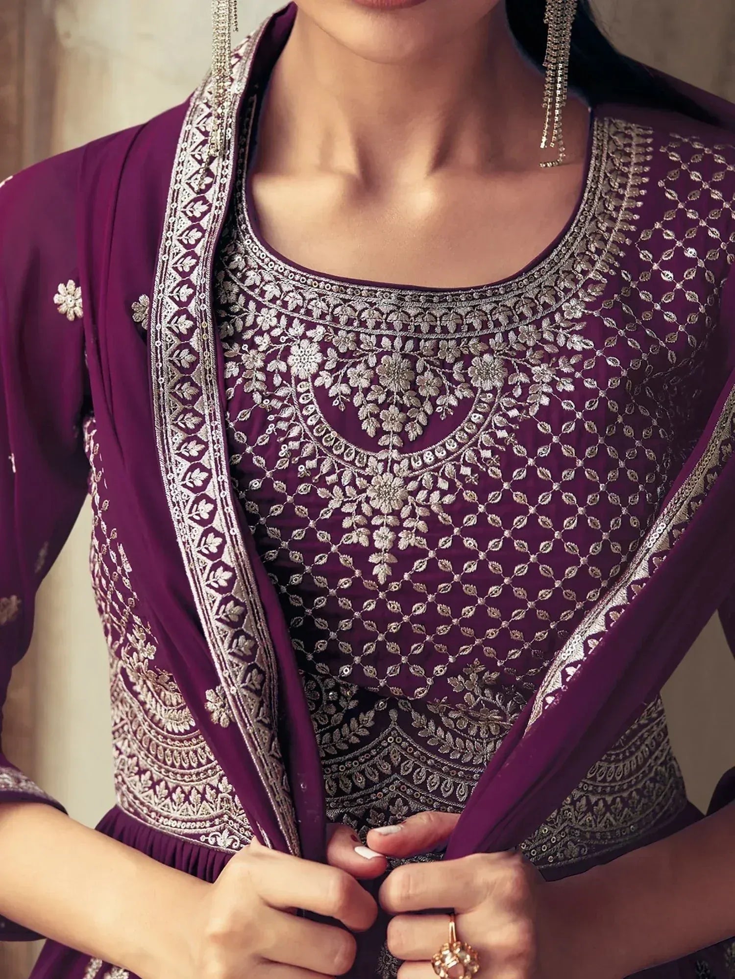 Elegant purple ethnic gown with intricate silver embroidery and floral patterns