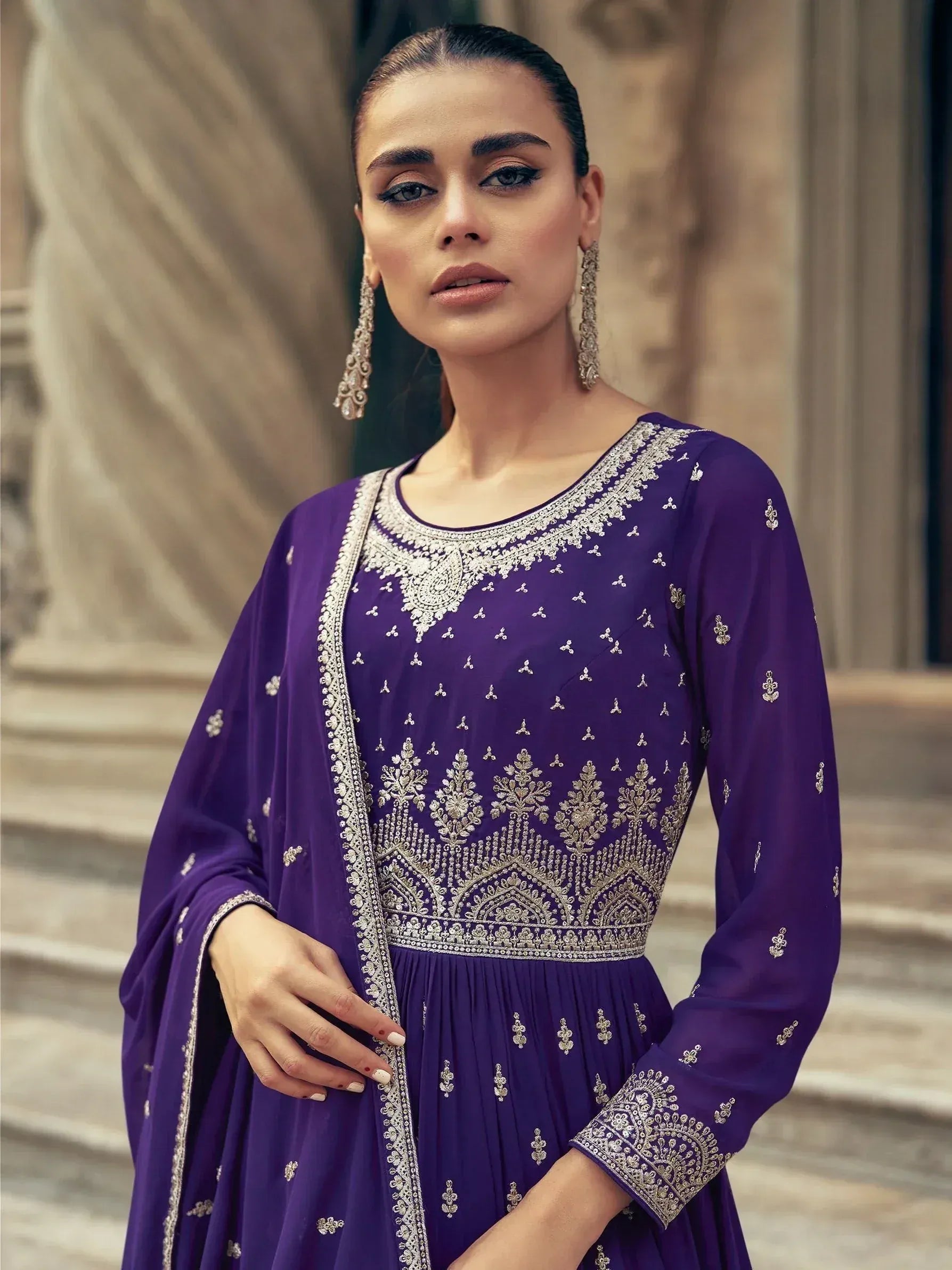 Purple embroidered ethnic gown with silver detailing, perfect for Indian festive occasions and weddings.