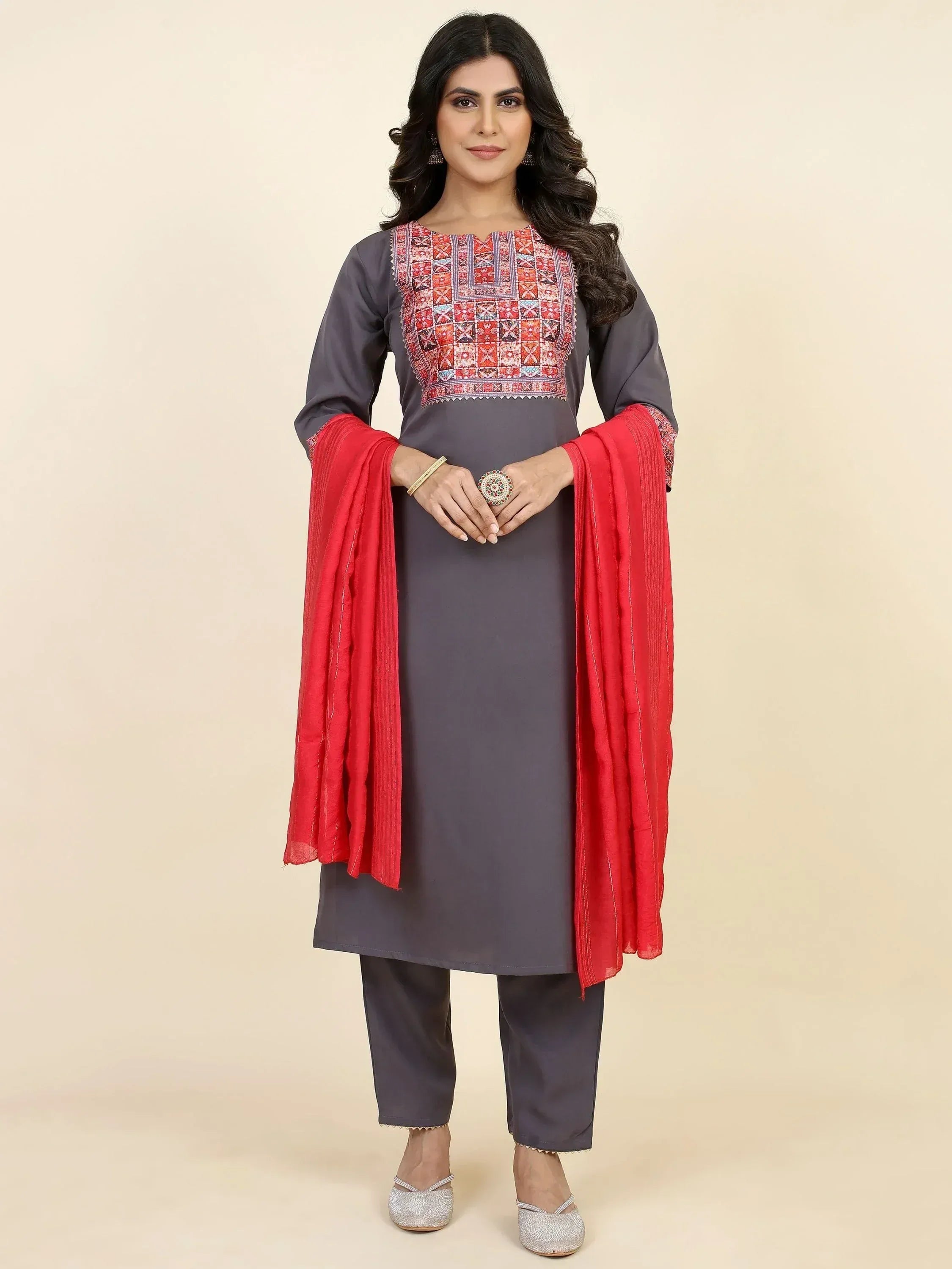 Grey embroidered kurta with red dupatta, paired with matching pants and silver heels for ethnic wear.