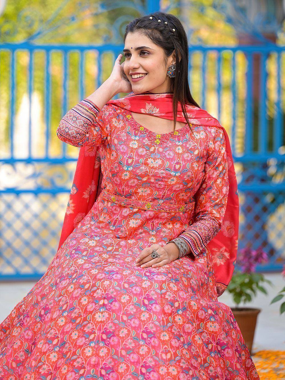 Woman in vibrant pink floral anarkali suit with matching dupatta, ethnic Indian wear