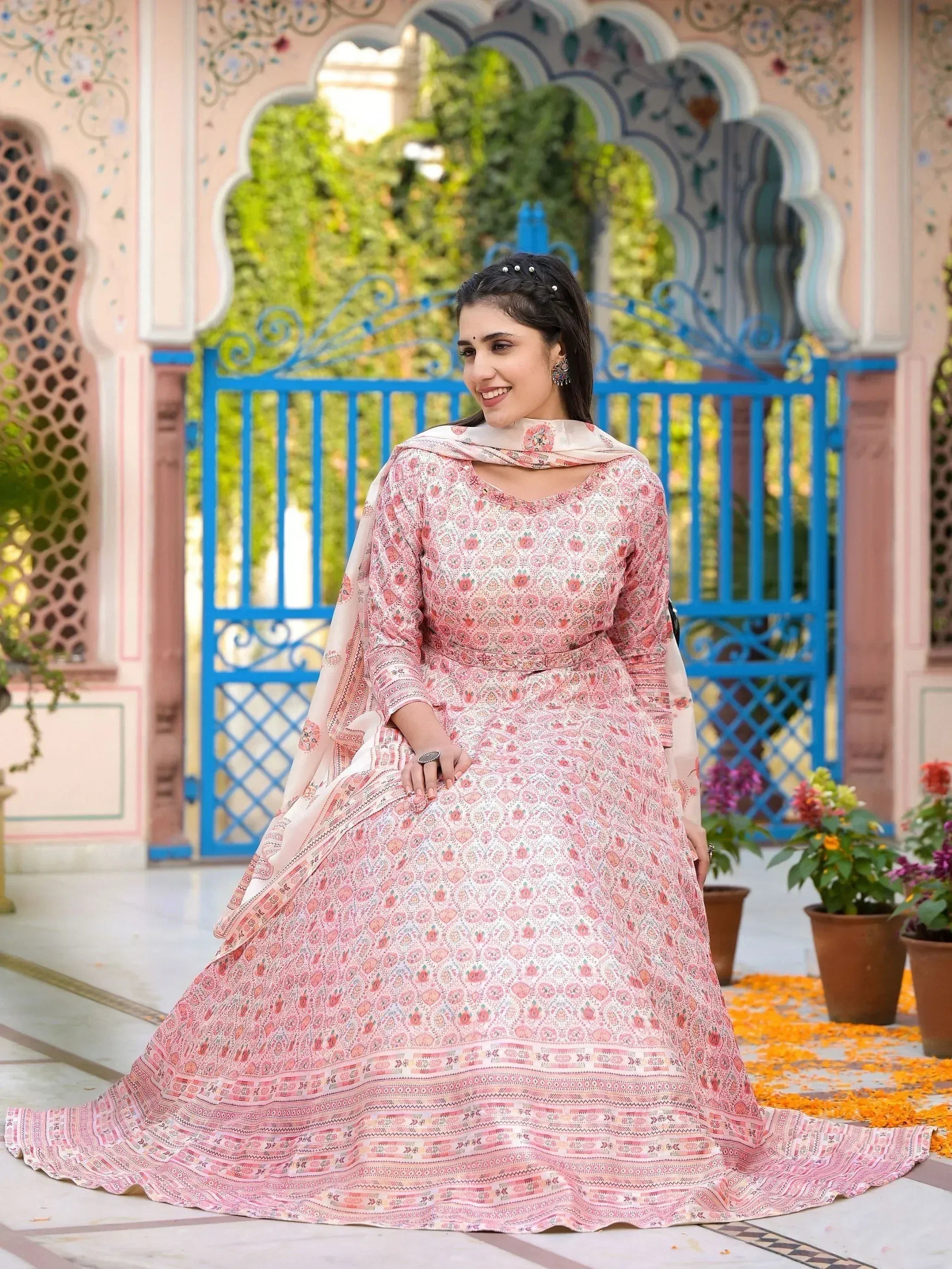 Woman in pink floral print Indian anarkali suit with dupatta, traditional ethnic wear for festive occasions