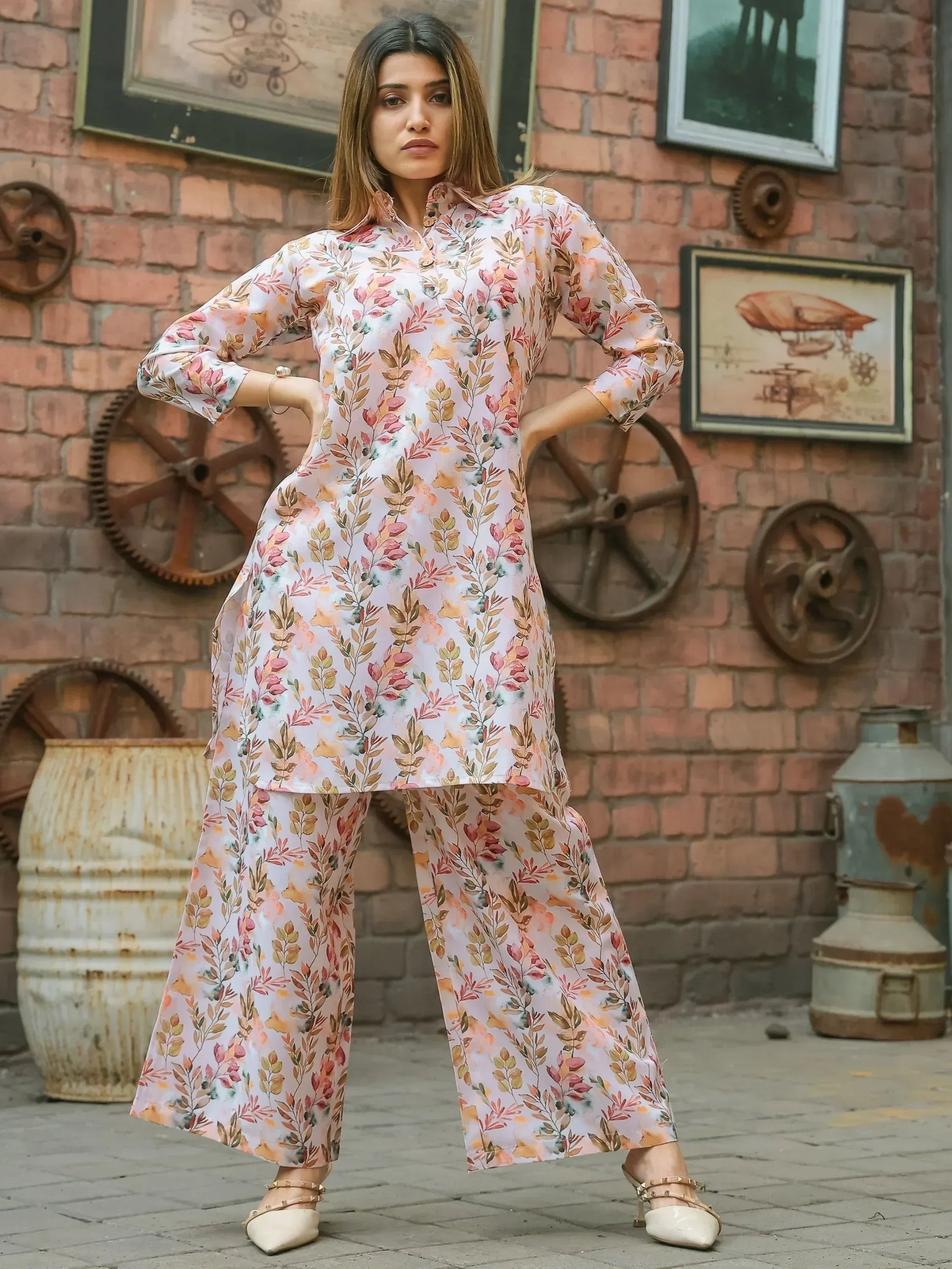 Woman wearing floral printed kurta and palazzo set with three-quarter sleeves, posing outdoors