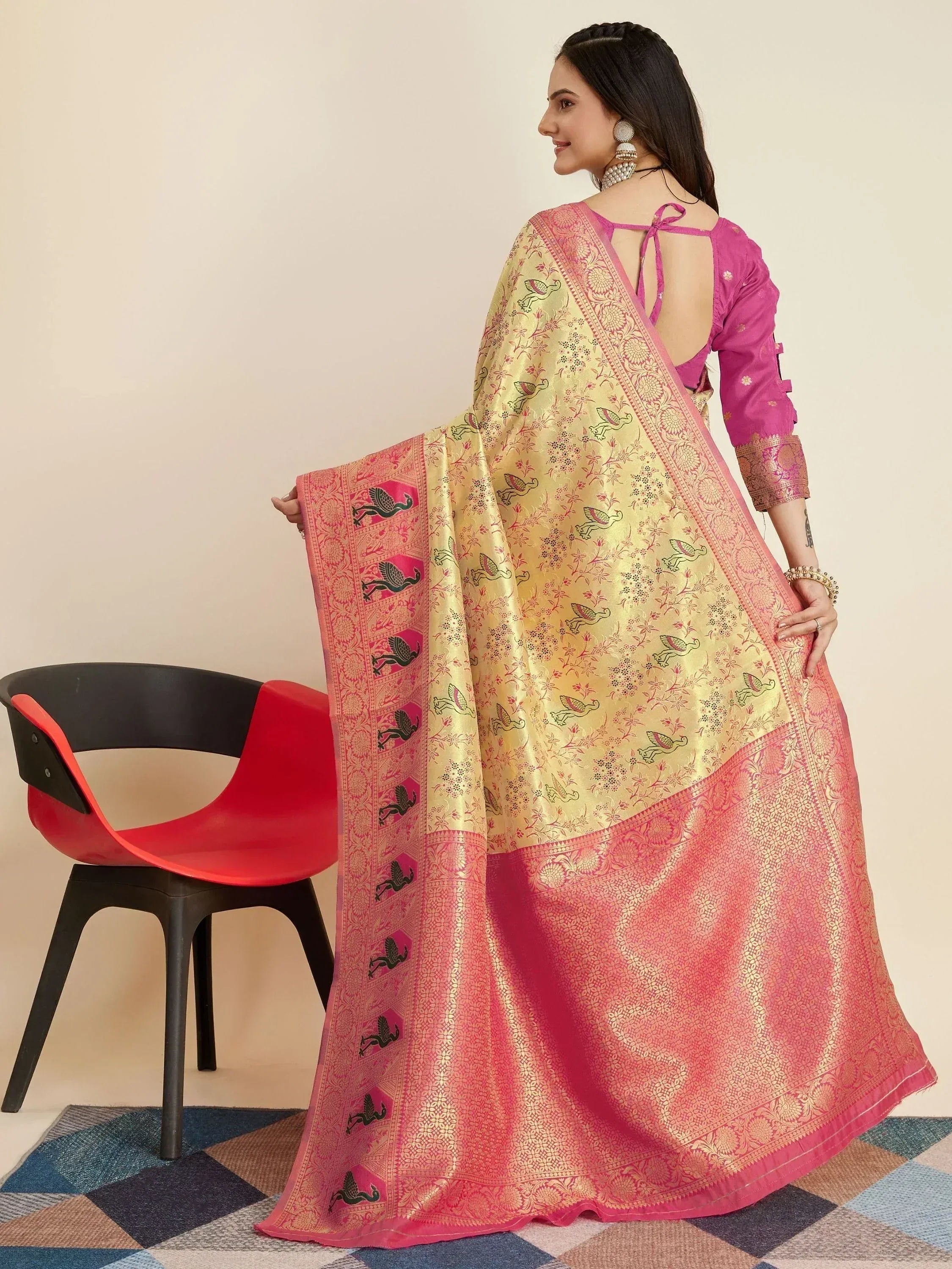 Pink and gold designer saree with bird motifs, paired with a back-tie blouse, ideal for ethnic occasions