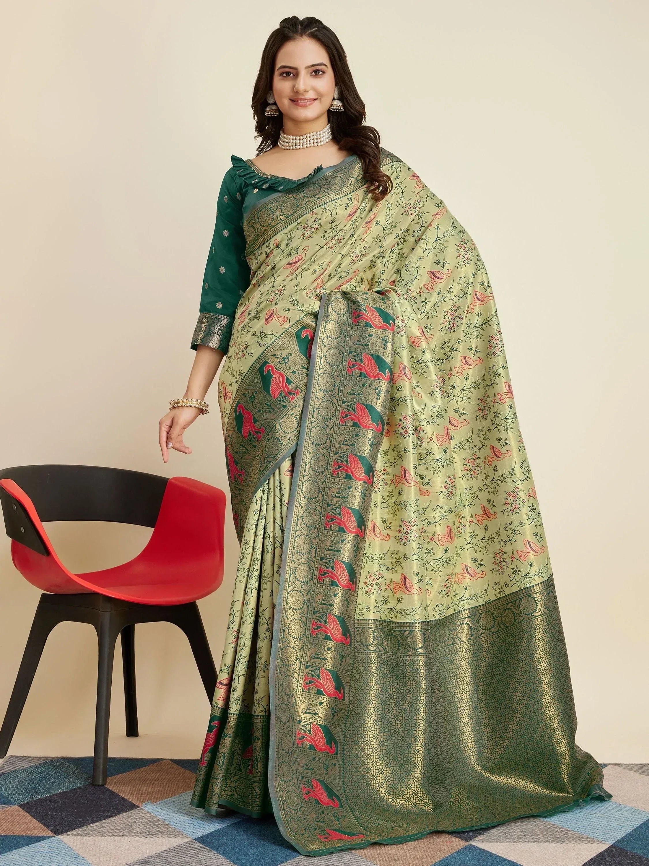 Elegant green saree with floral and bird motifs, paired with a matching blouse, perfect for ethnic occasions.