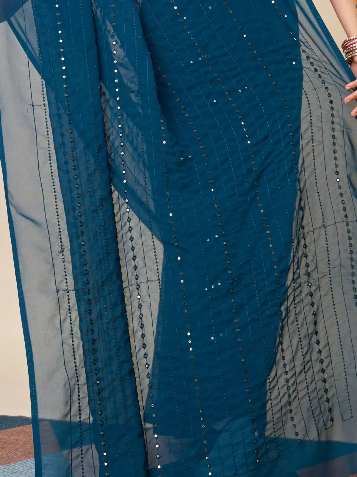 Teal blue ethnic gown with sequin embroidery and sheer overlay, perfect for Indian occasions.