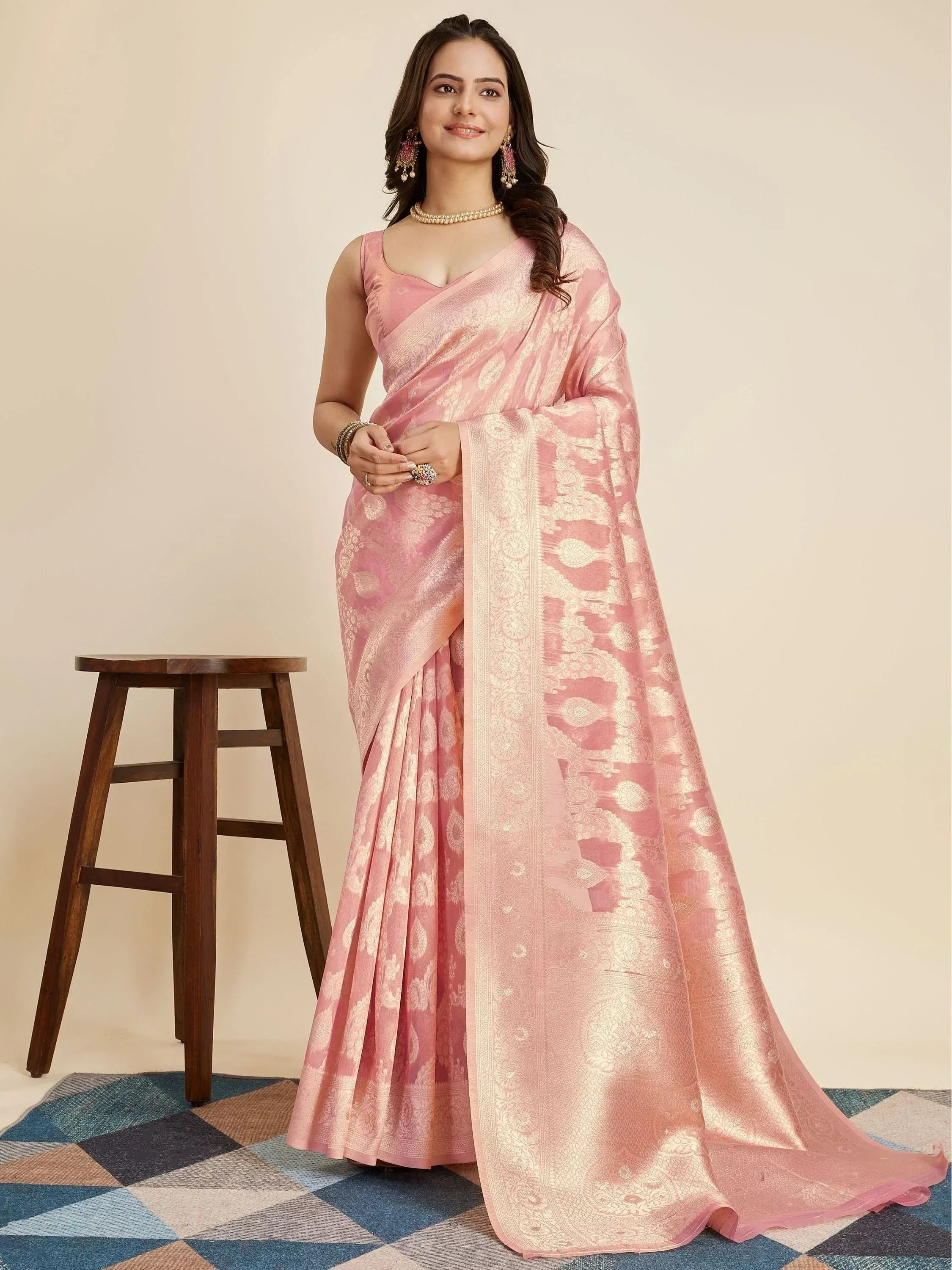 Pink designer saree with gold floral motifs, perfect for Indian ethnic wear occasions.