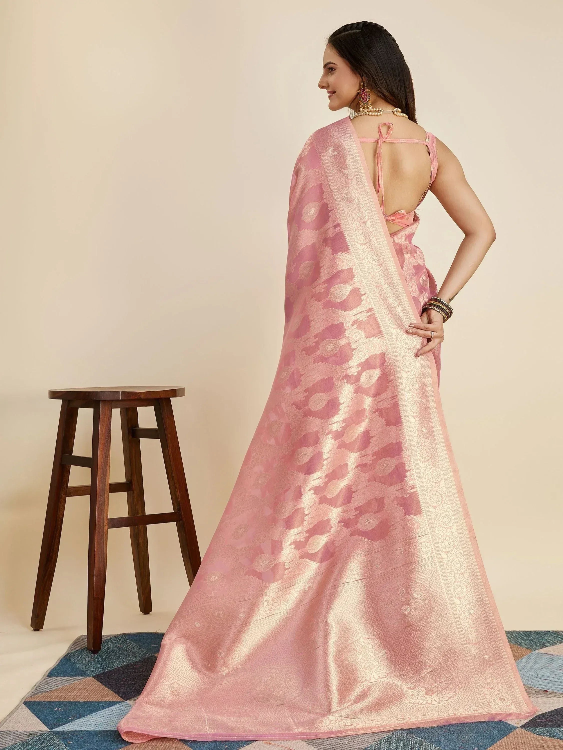 Pink designer saree with gold floral embroidery and backless blouse, perfect for Indian ethnic occasions