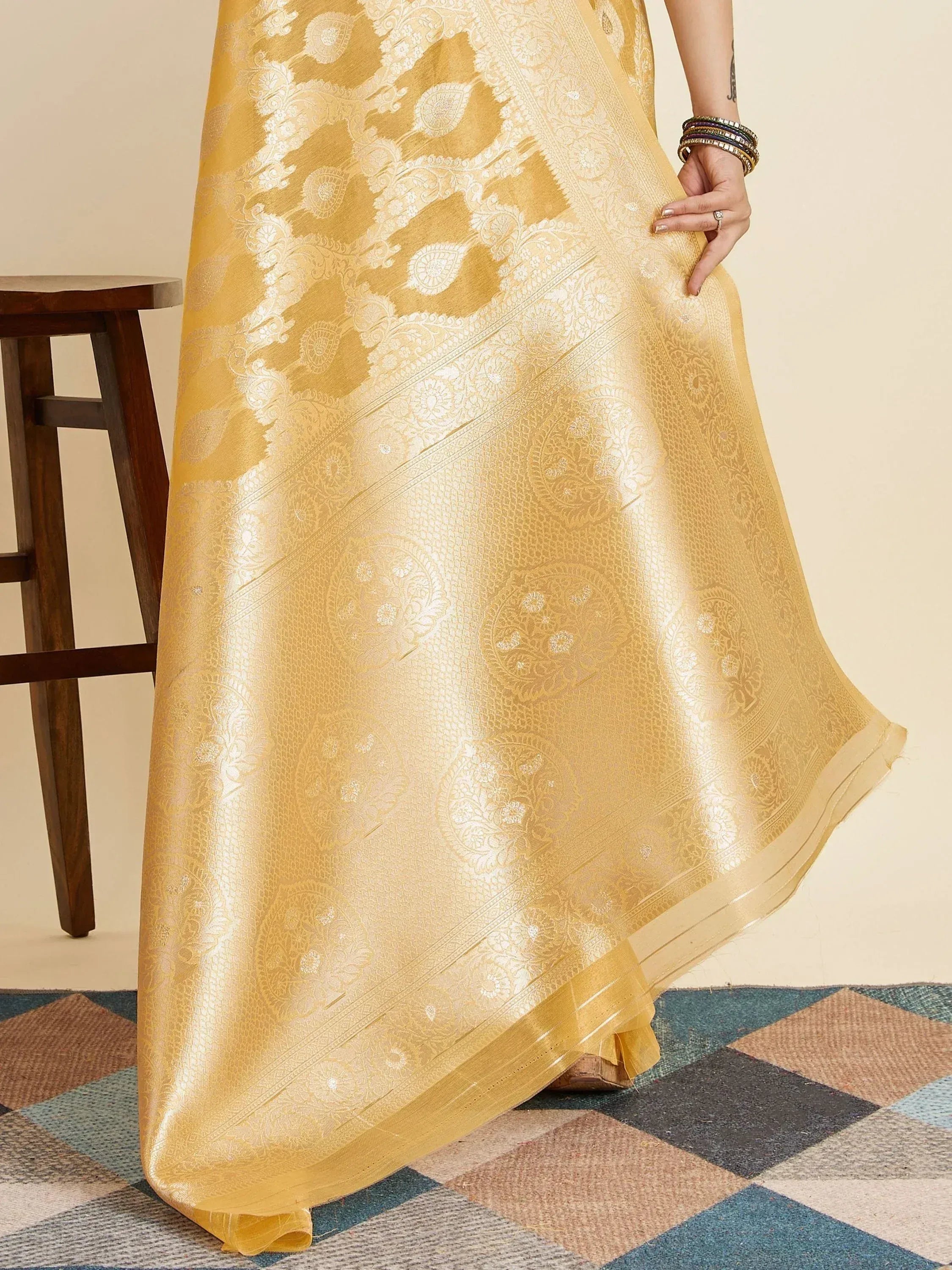 Golden designer saree with intricate white floral embroidery, perfect for ethnic occasions