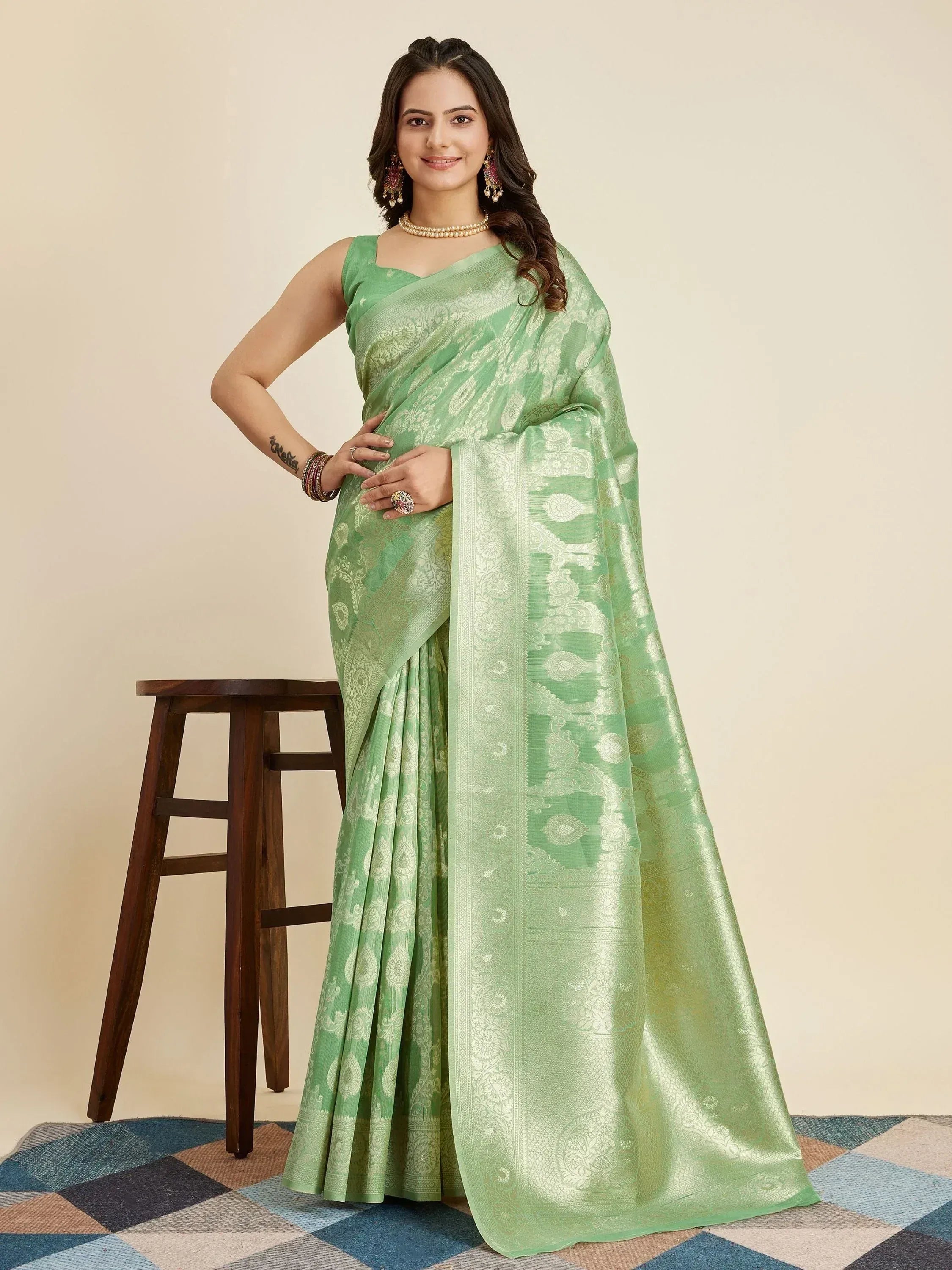 Mint green designer saree with intricate gold paisley weave, perfect for ethnic occasions