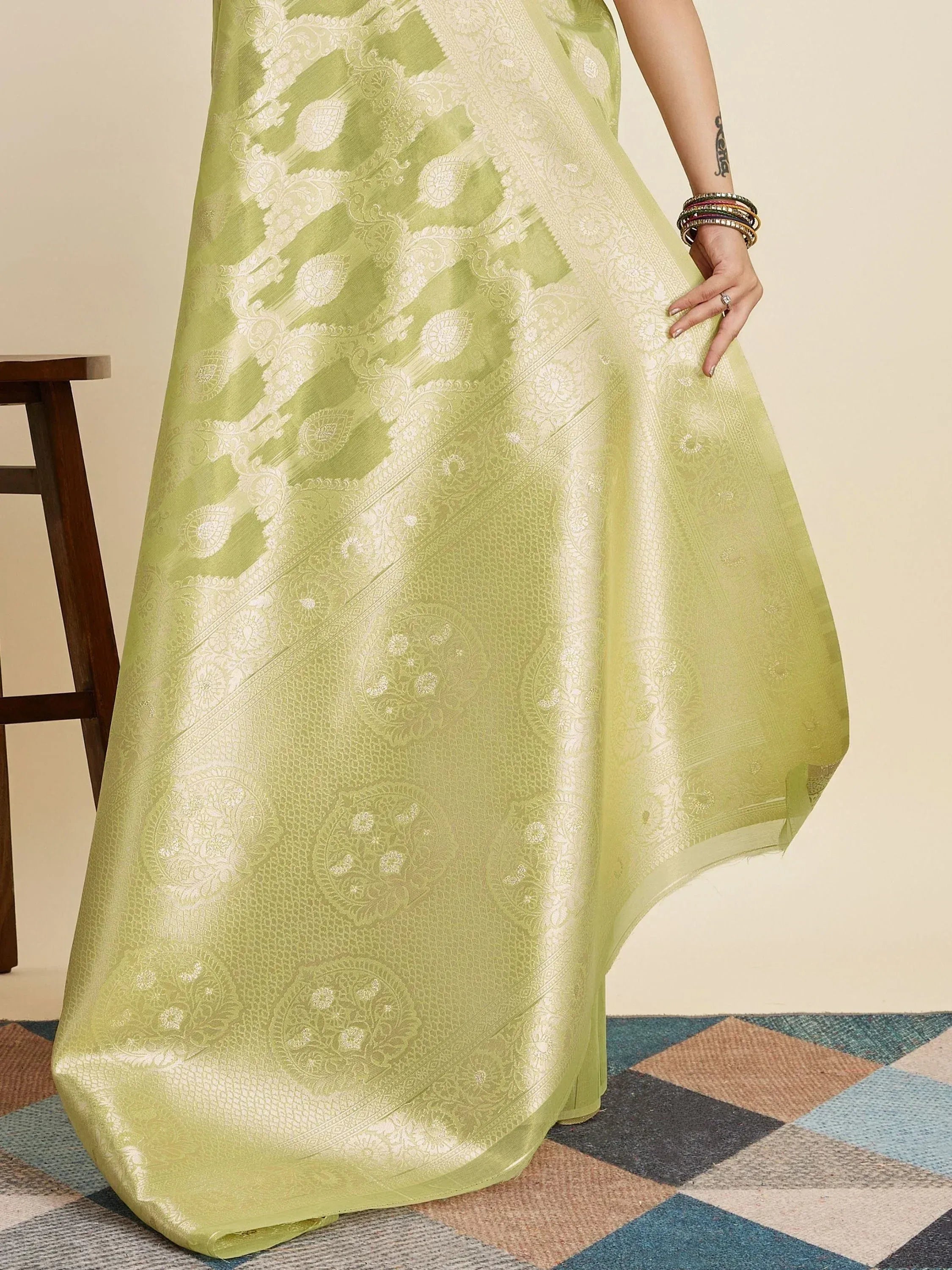 Light green ethnic gown with intricate white paisley and floral woven patterns, perfect for Indian occasions