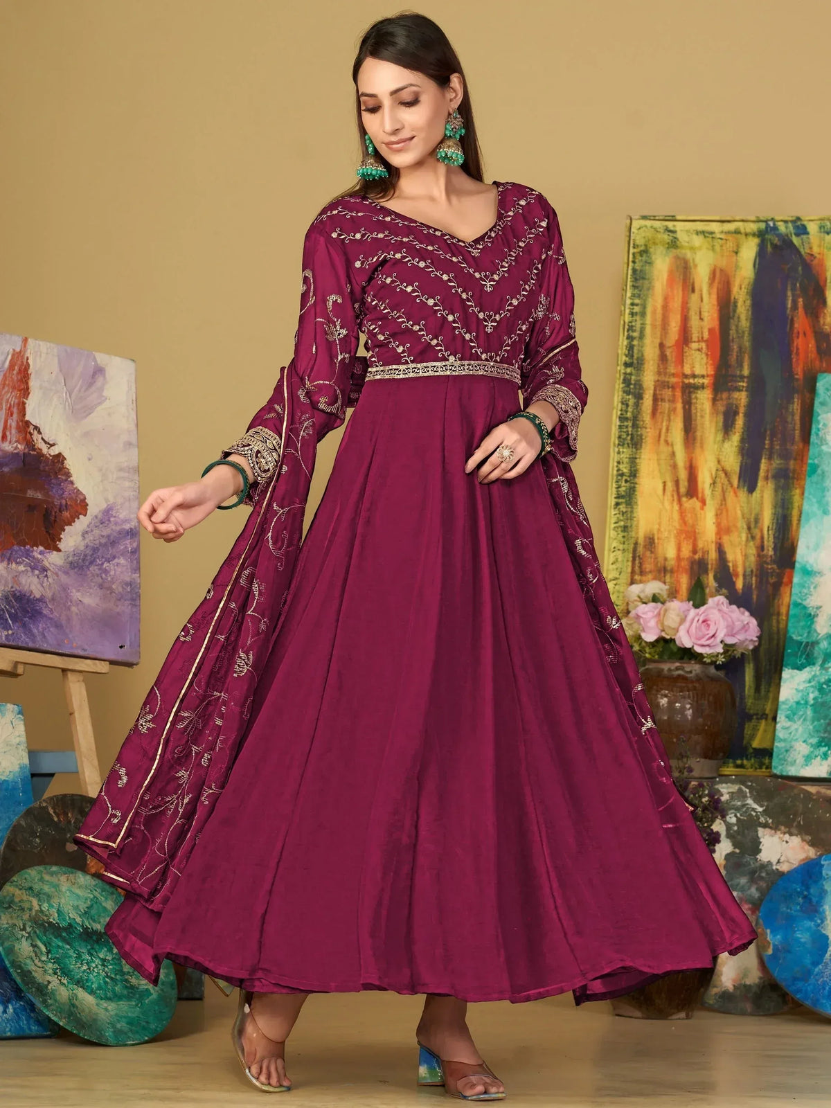 Elegant maroon ethnic gown with gold embroidery, perfect for Indian occasions and festive wear.