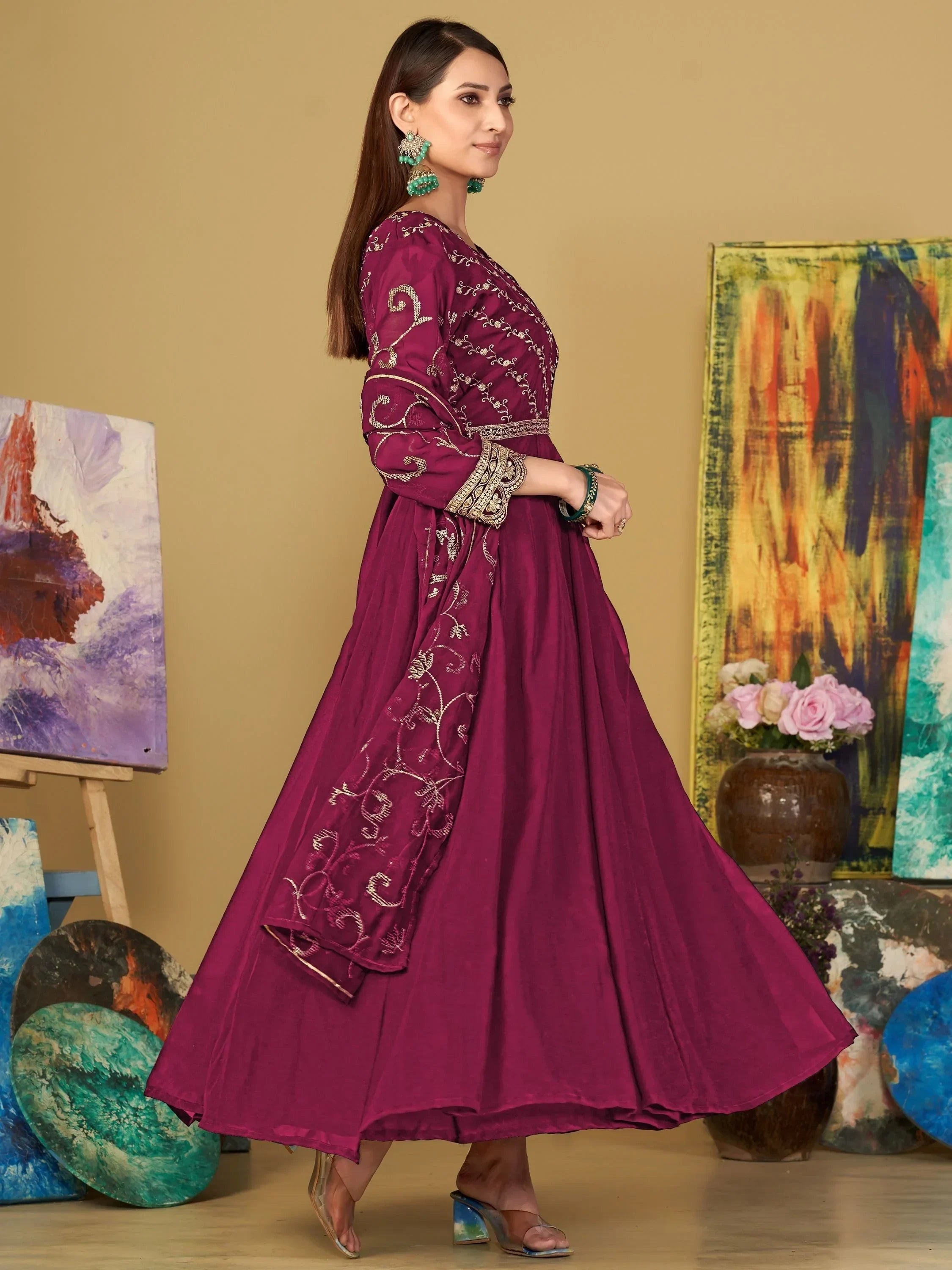 Woman in magenta embroidered anarkali dress with dupatta, ethnic wear, art studio background