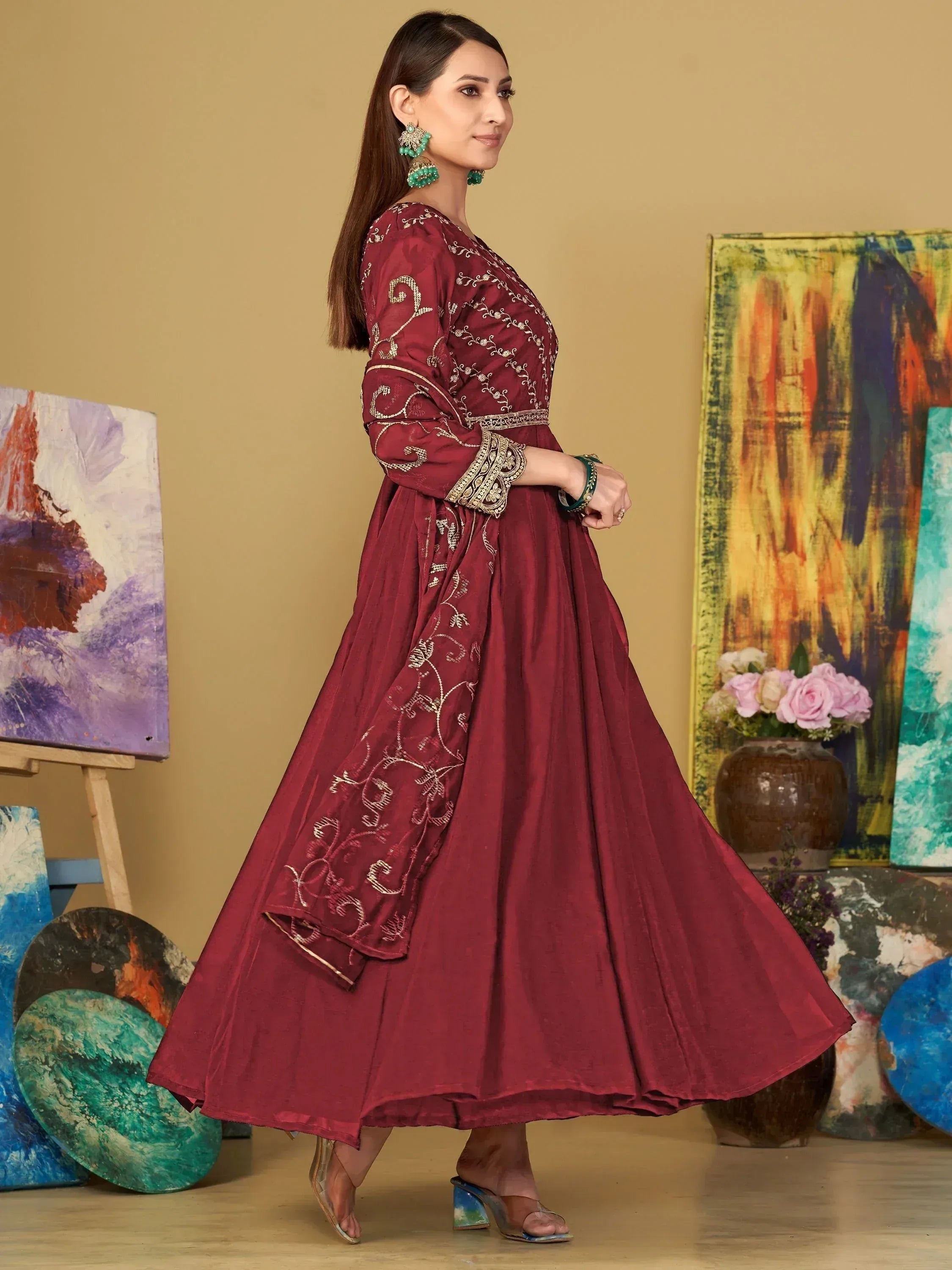 Maroon ethnic gown with gold embroidery, perfect for Indian festive occasions and weddings