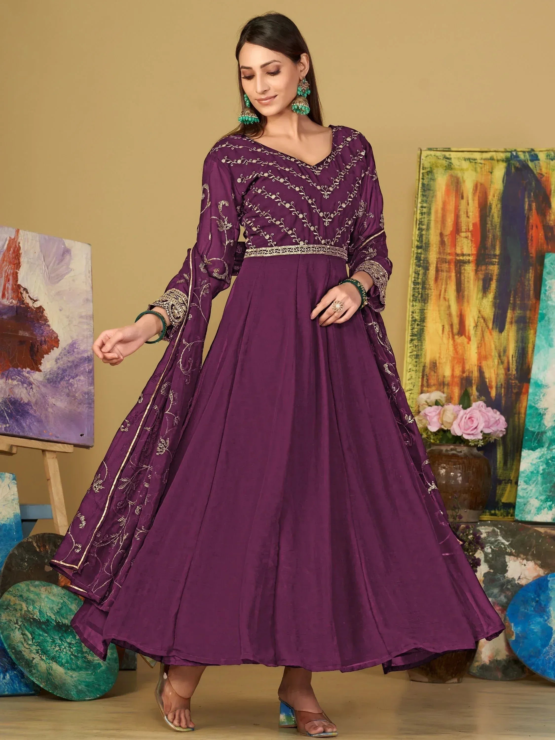 Purple embroidered ethnic gown with gold detailing, perfect for Indian occasions and festive wear.