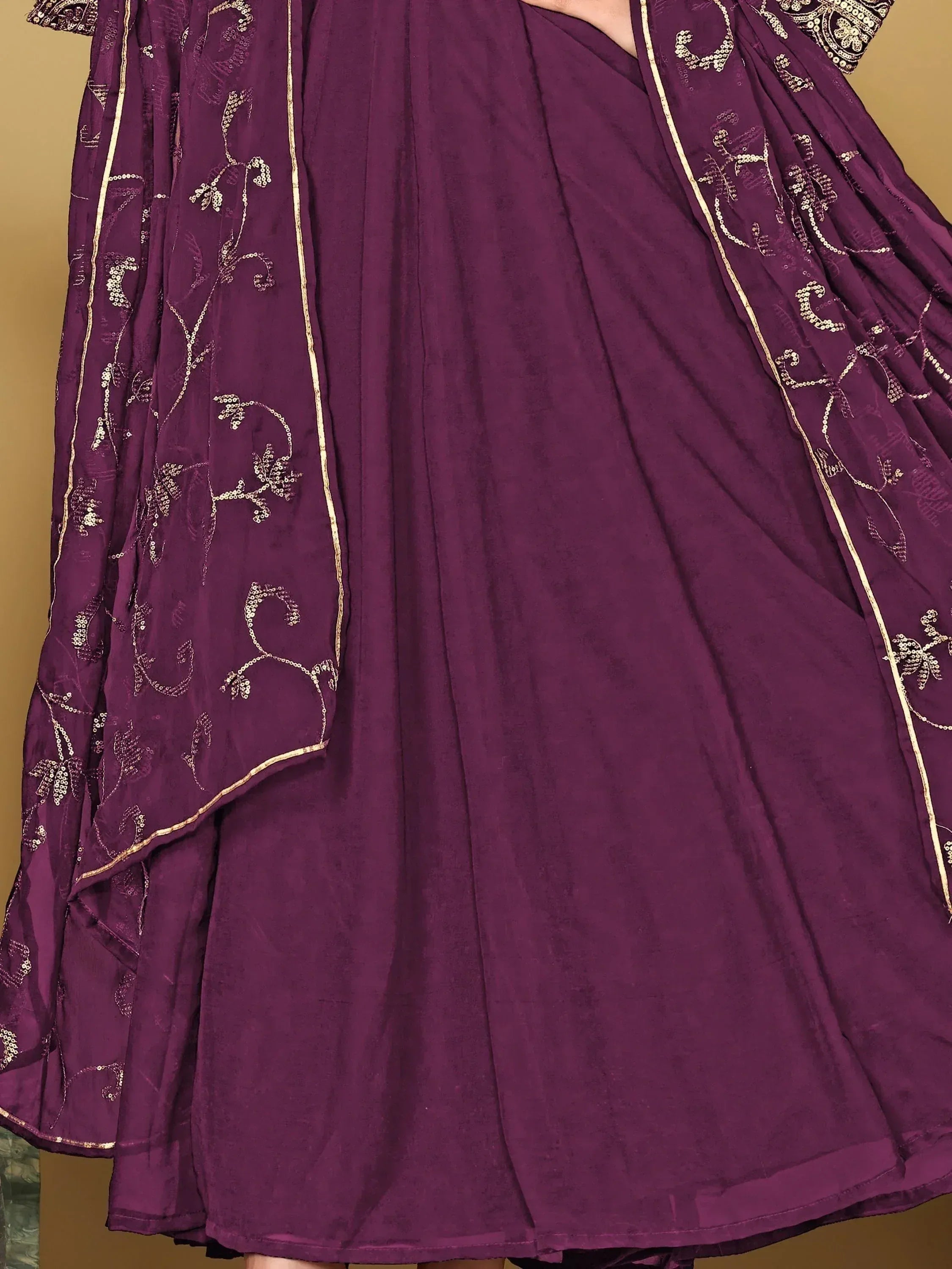 Purple ethnic gown with gold embroidery and sequin detailing, perfect for Indian occasions