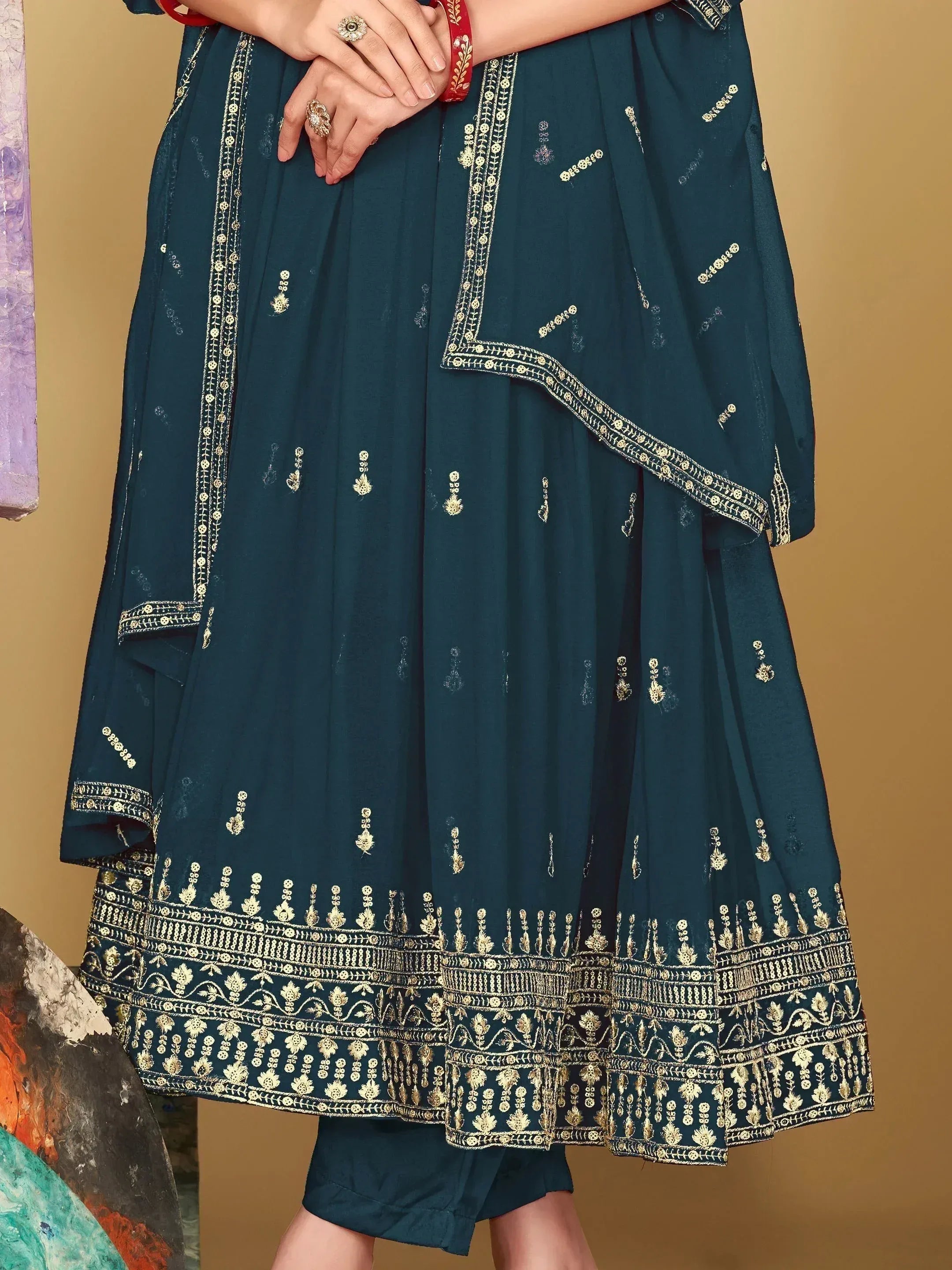 Teal ethnic anarkali with gold embroidery, perfect for Indian weddings or festive occasions.