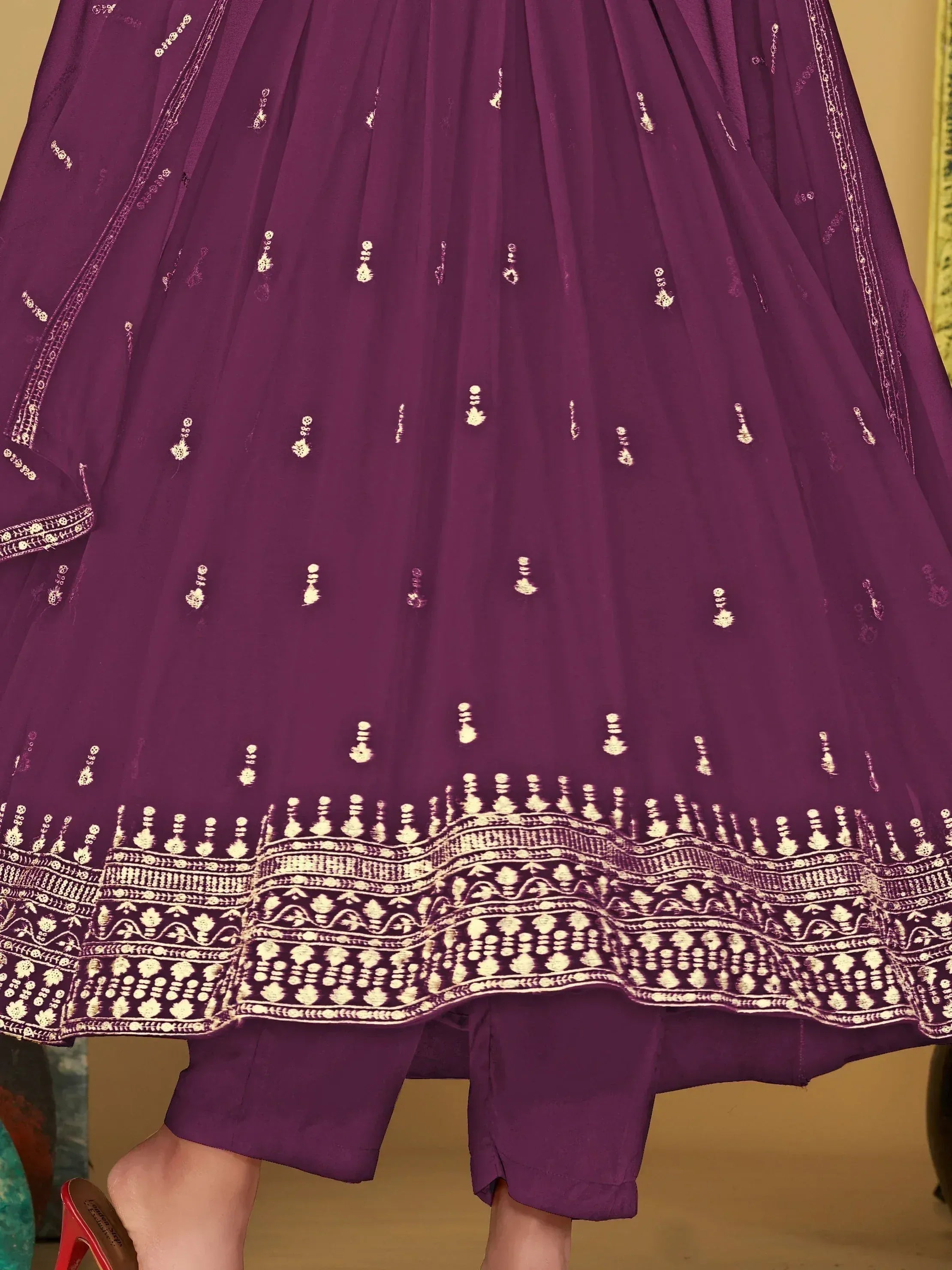 Purple ethnic gown with gold embroidery and intricate border design