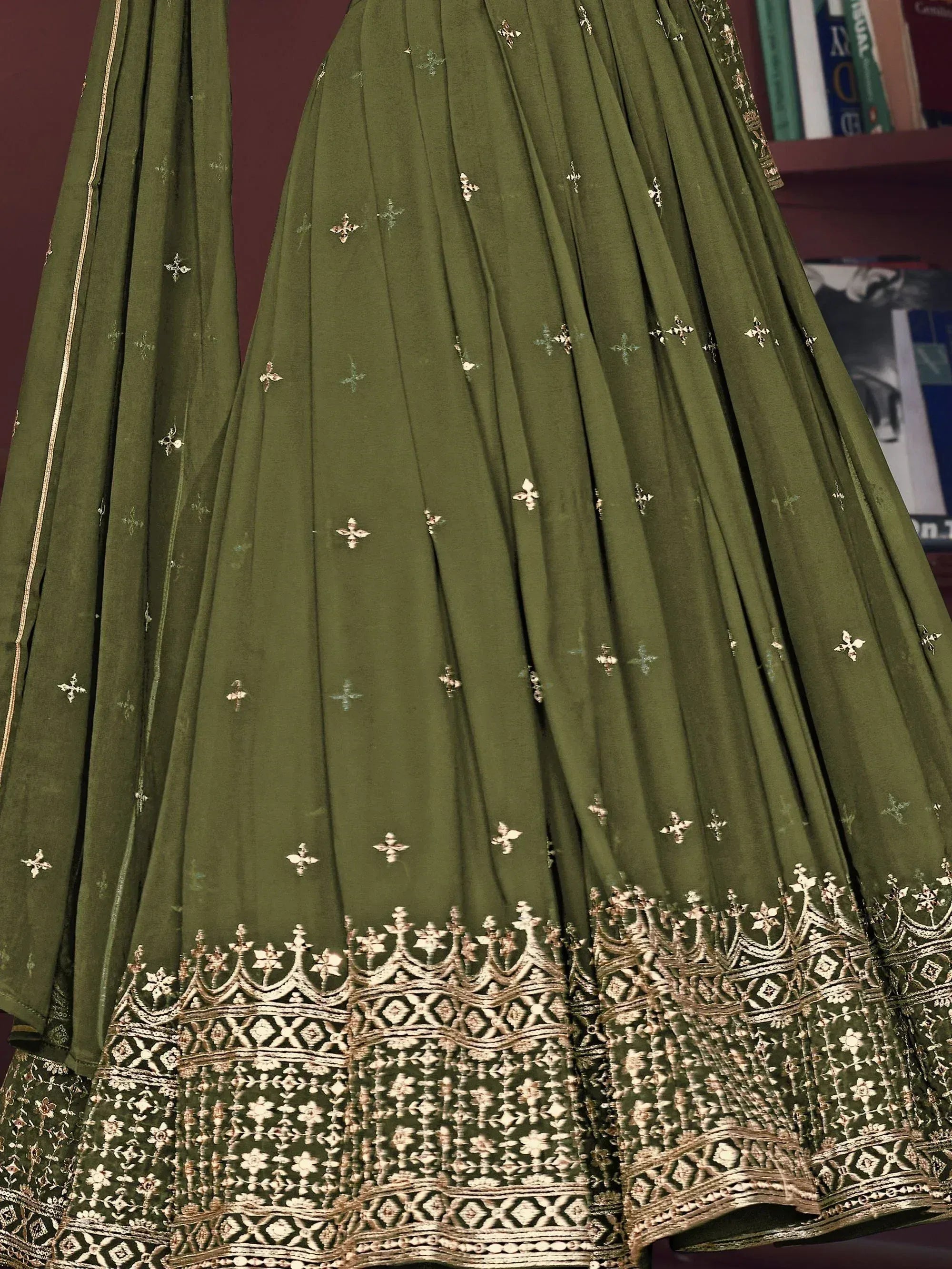 Olive green embroidered lehenga choli with gold floral motifs and detailed border, perfect for Indian ethnic wear.
