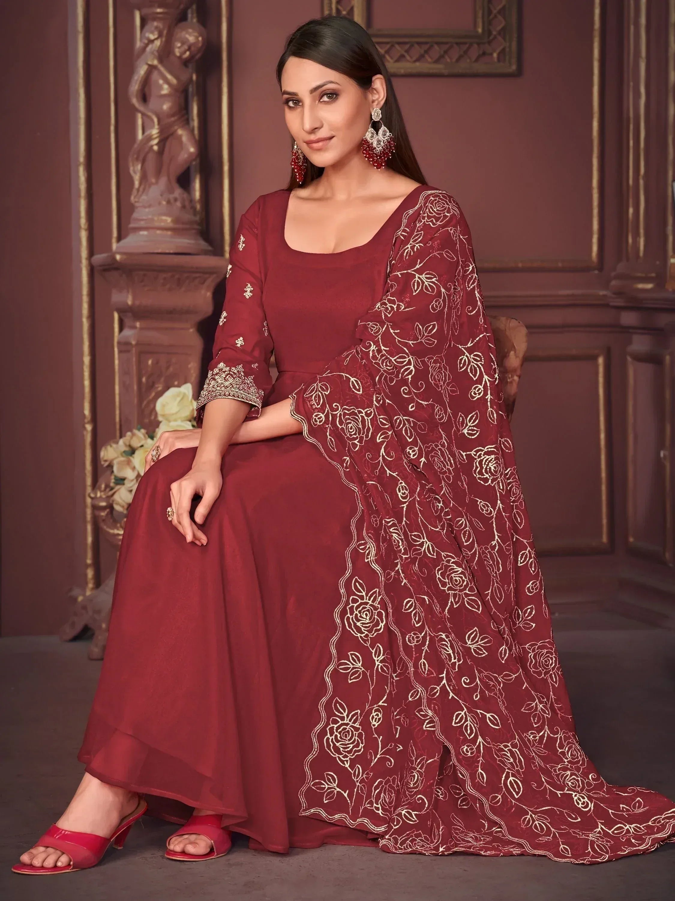 Maroon ethnic gown with gold floral embroidery, perfect for Indian weddings and festive occasions