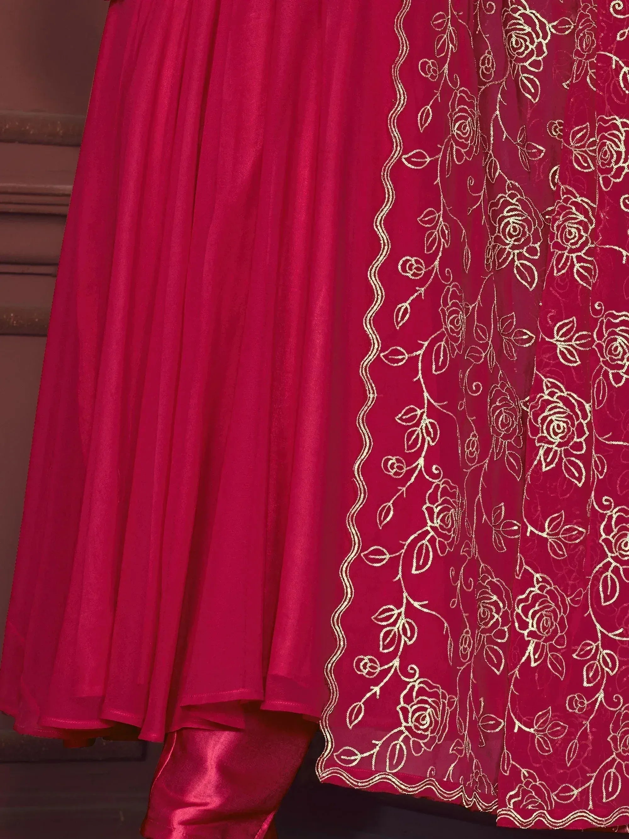Red ethnic gown with gold rose embroidery, perfect for Indian weddings and festive occasions