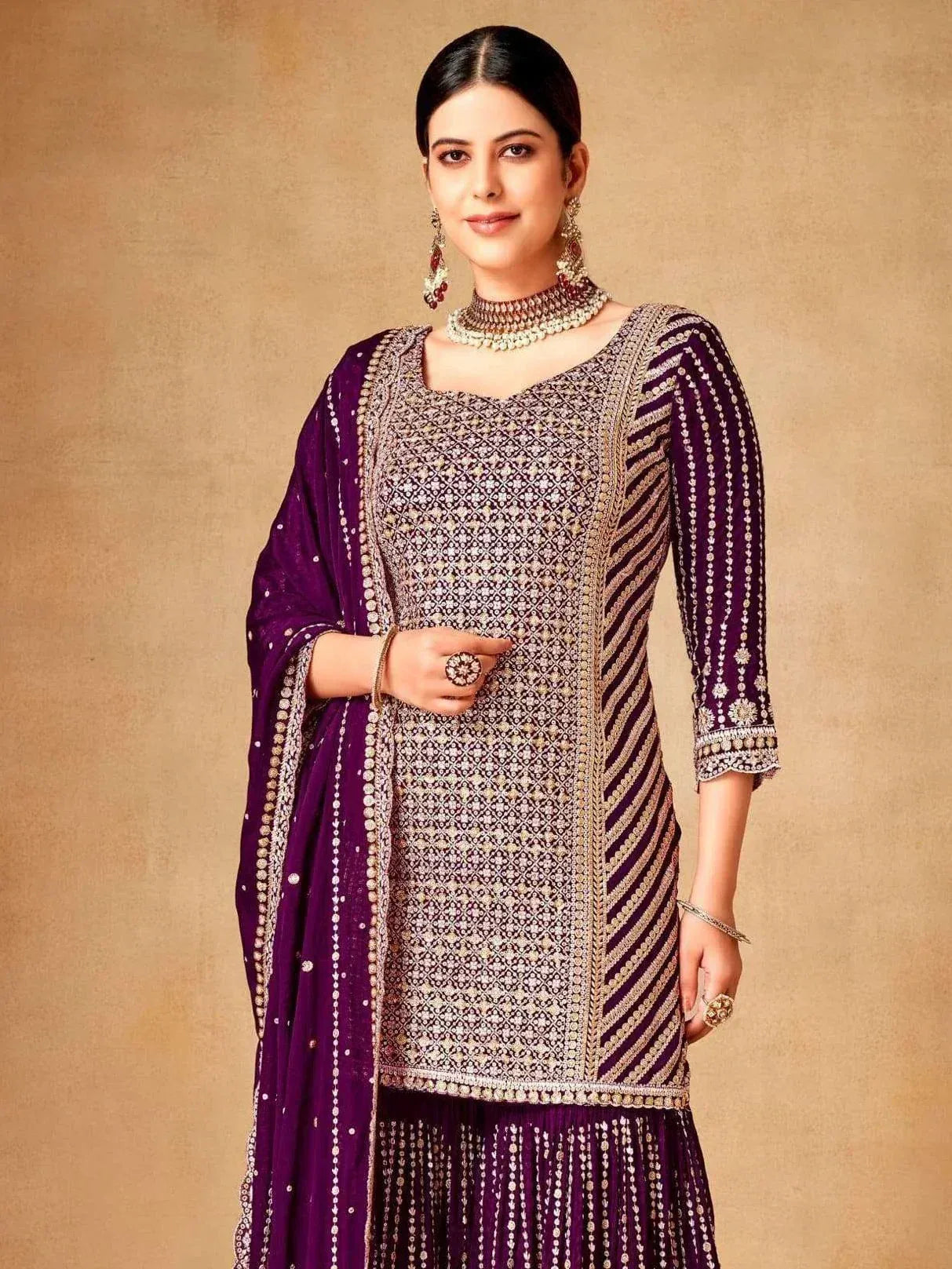 Purple embroidered salwar kameez with gold detailing, perfect for Indian ethnic wear occasions.