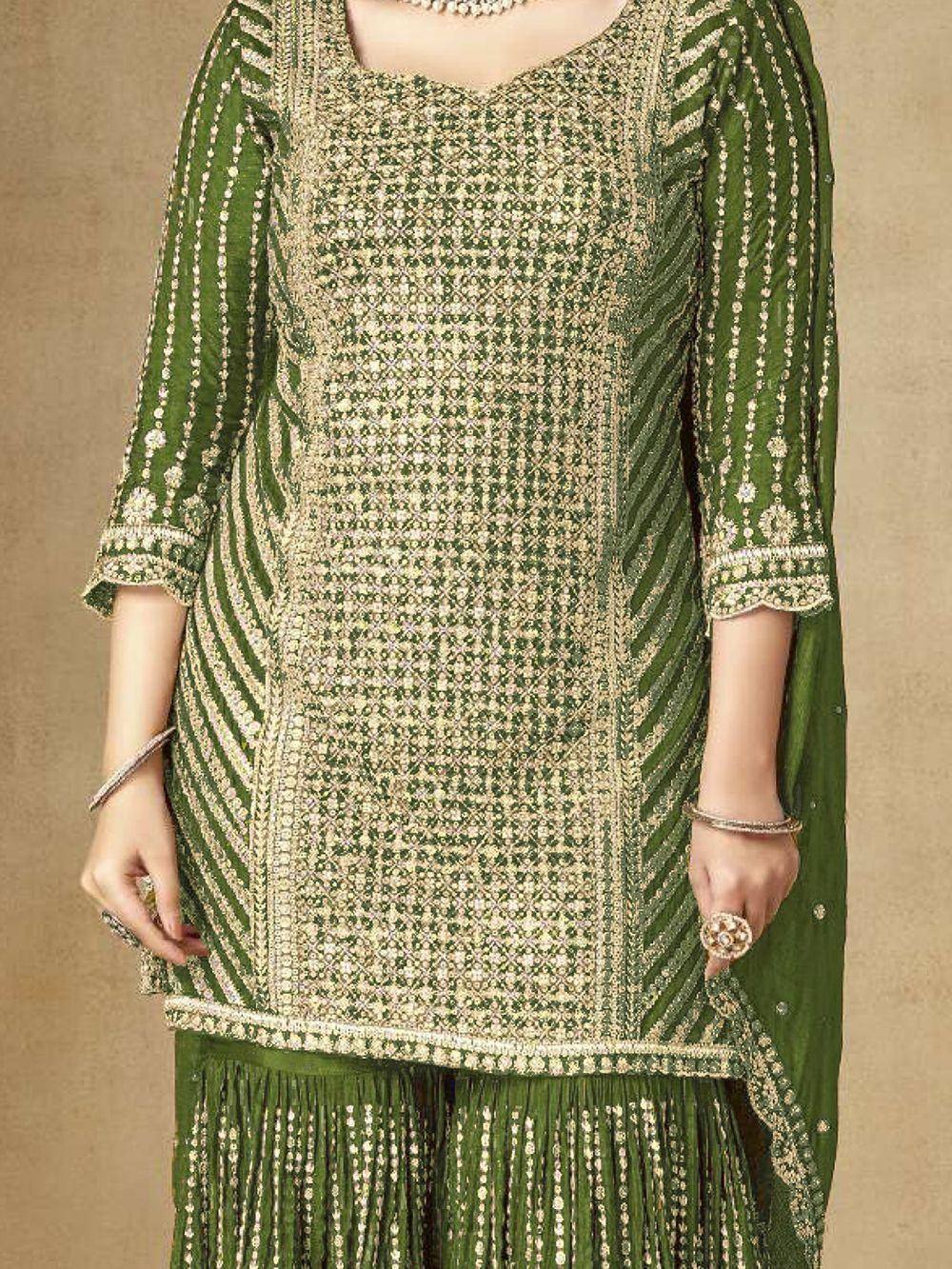 Green embroidered ethnic salwar kameez with gold detailing and fringe hem, perfect for festive occasions.