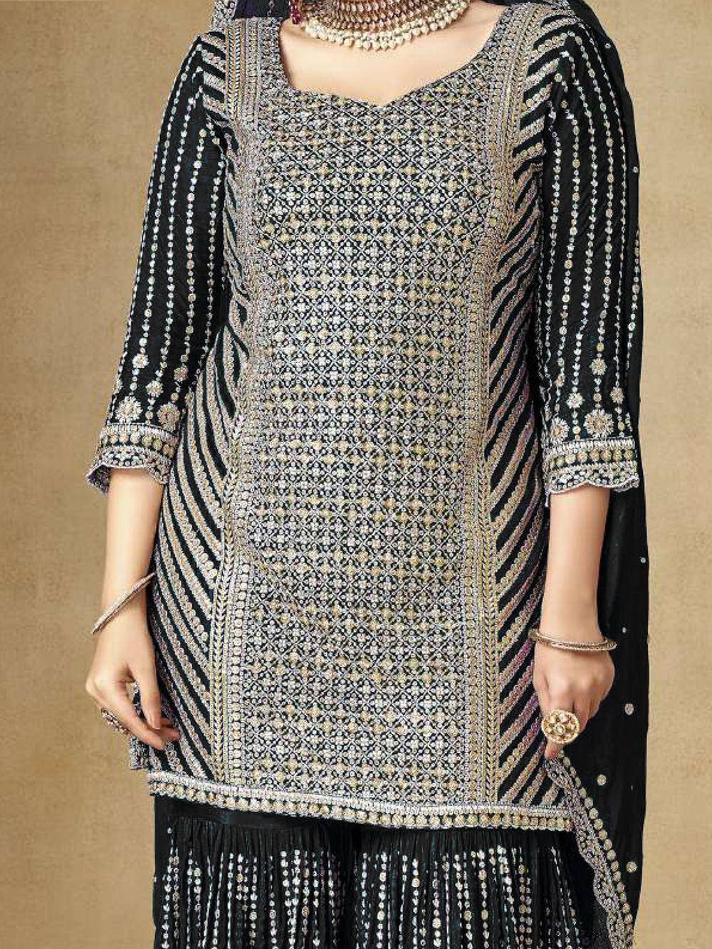 Black and gold embroidered ethnic kurti with detailed patterns and fringe hem, paired with matching dupatta
