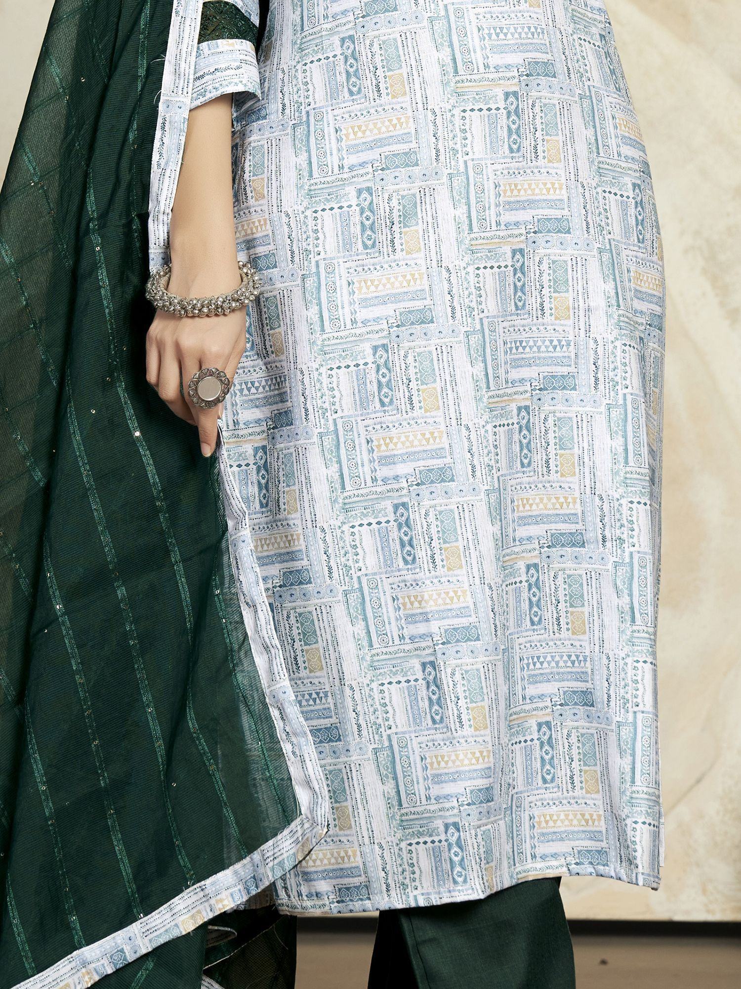 Woman wearing green and white printed salwar kameez with dupatta and silver jewelry