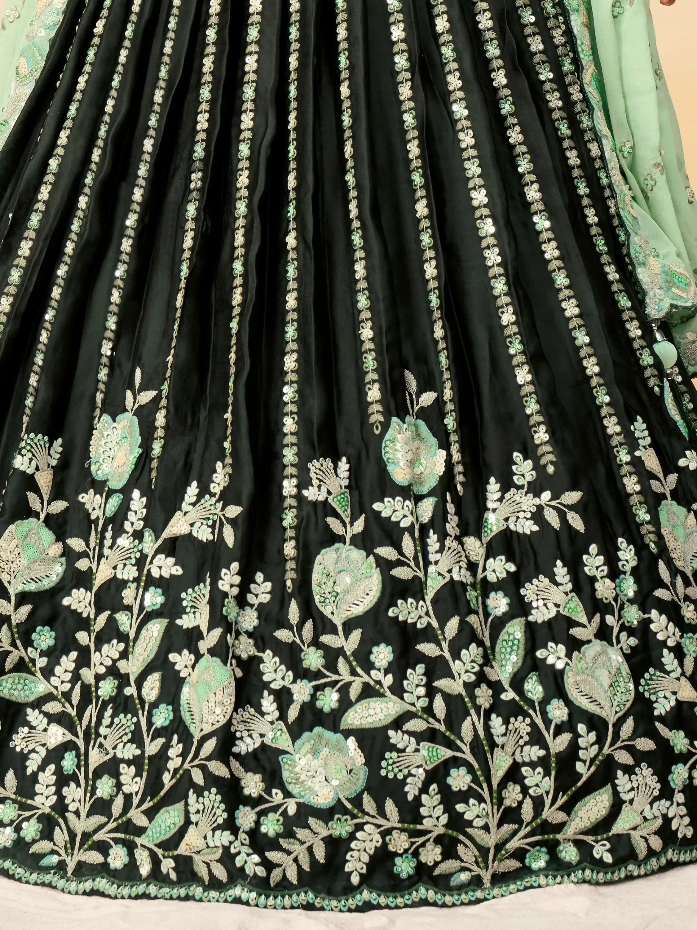 Black lehenga with mint green floral embroidery and sequin detailing, perfect for Indian ethnic wear.
