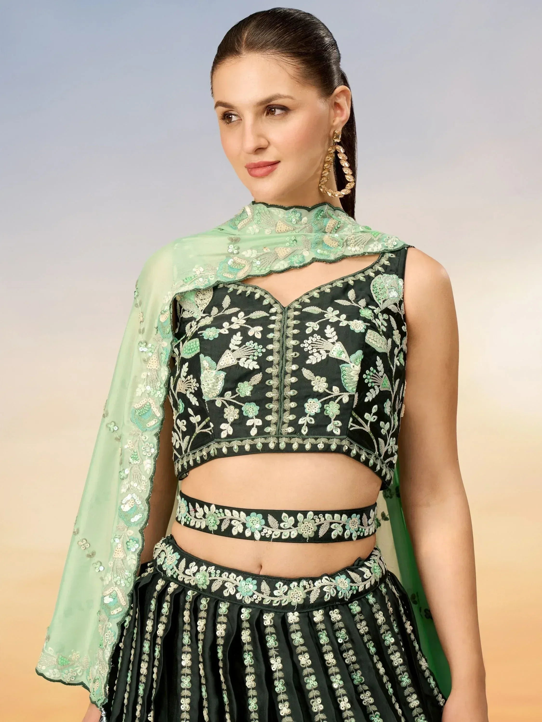 Green embroidered lehenga choli with floral motifs and matching dupatta, ideal for Indian ethnic wear occasions.