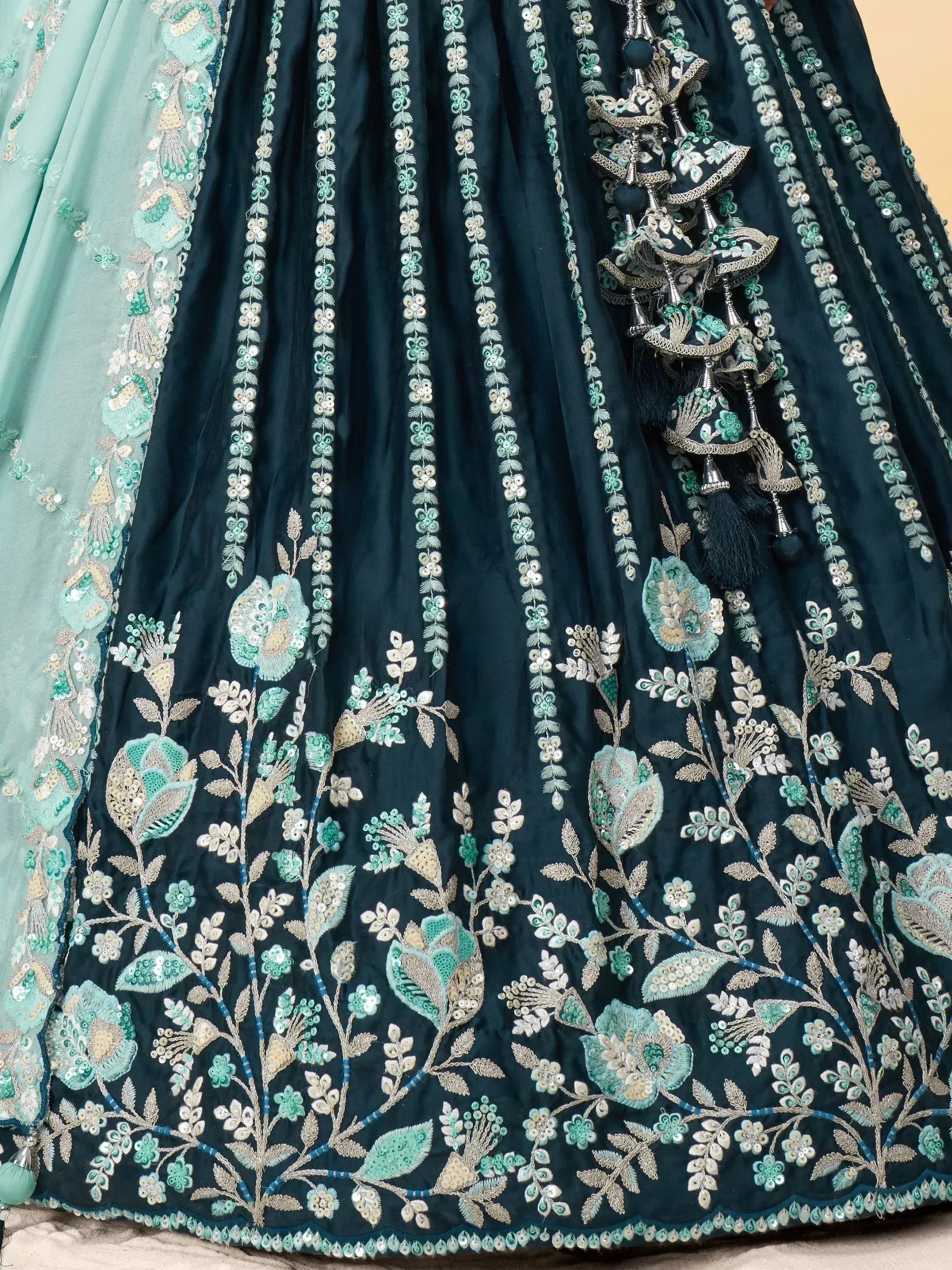 Dark green lehenga with mint floral embroidery, sequins, and tassels for Indian ethnic wear