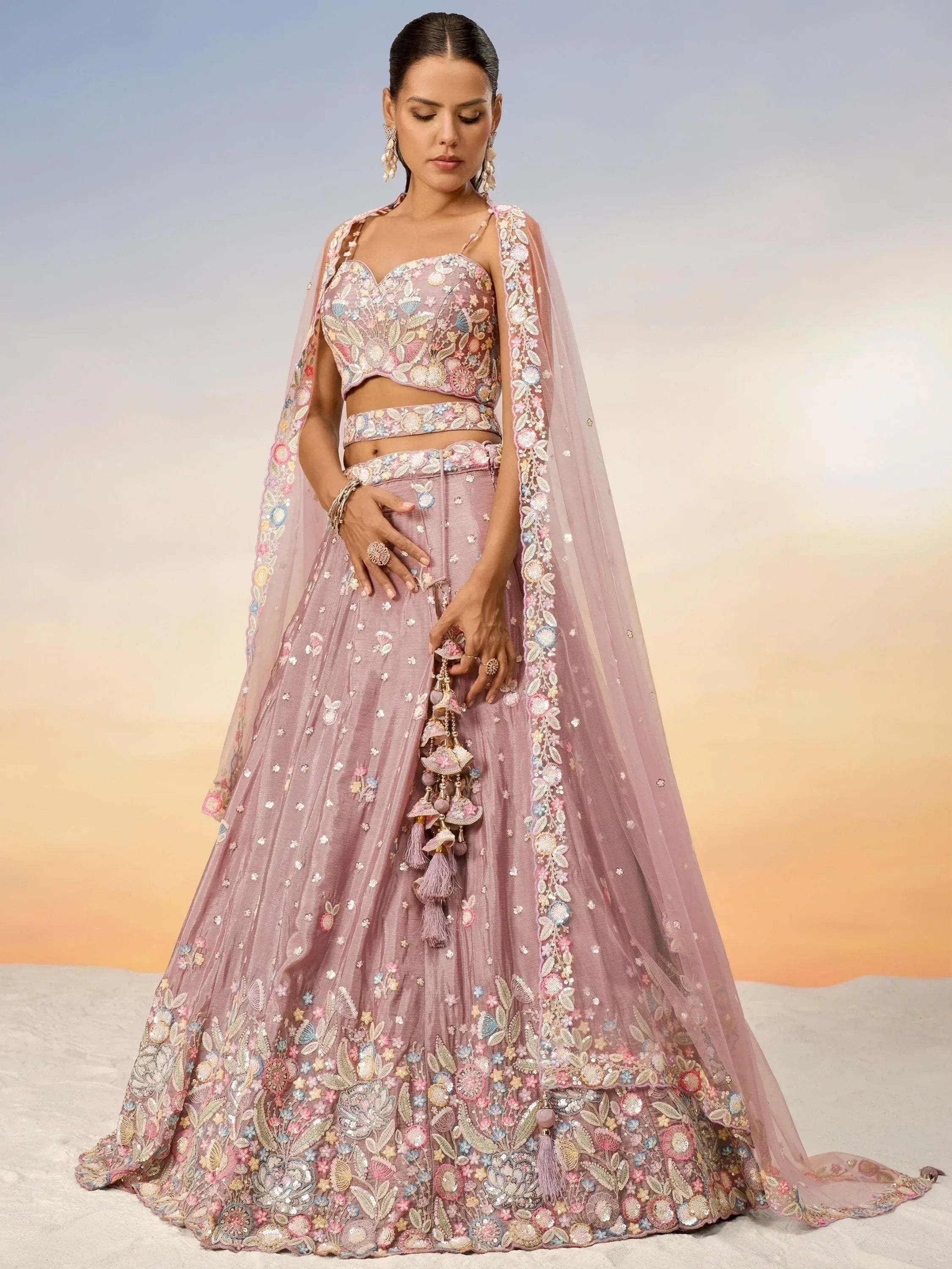 Pink floral embroidered lehenga choli with sheer dupatta, perfect for Indian weddings and festive occasions.