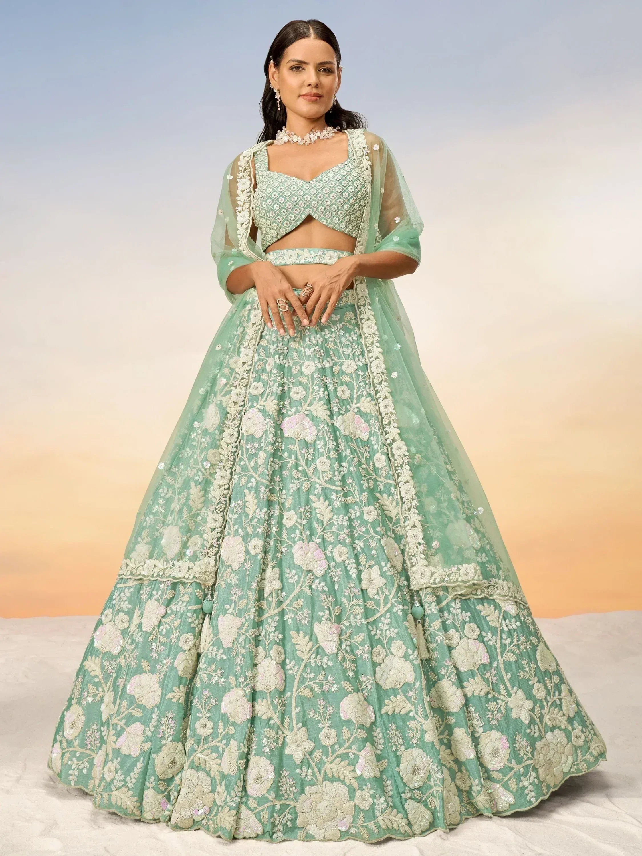 Mint green floral embroidered lehenga choli with sheer dupatta, perfect for Indian weddings and festive occasions.