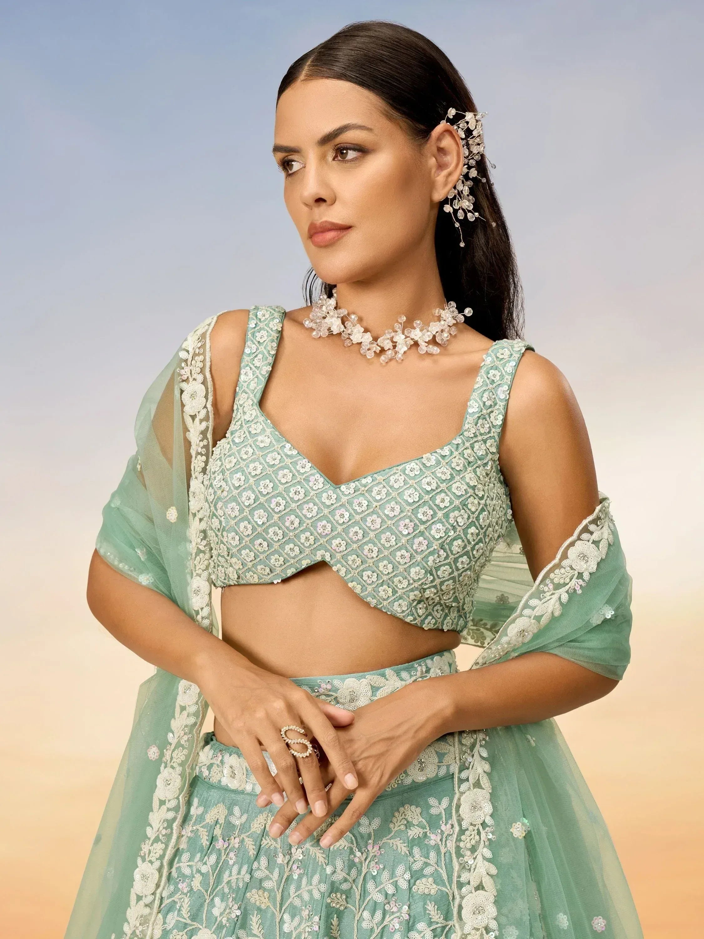 Mint green designer lehenga choli with floral embroidery and sequins, perfect for Indian ethnic wear occasions.