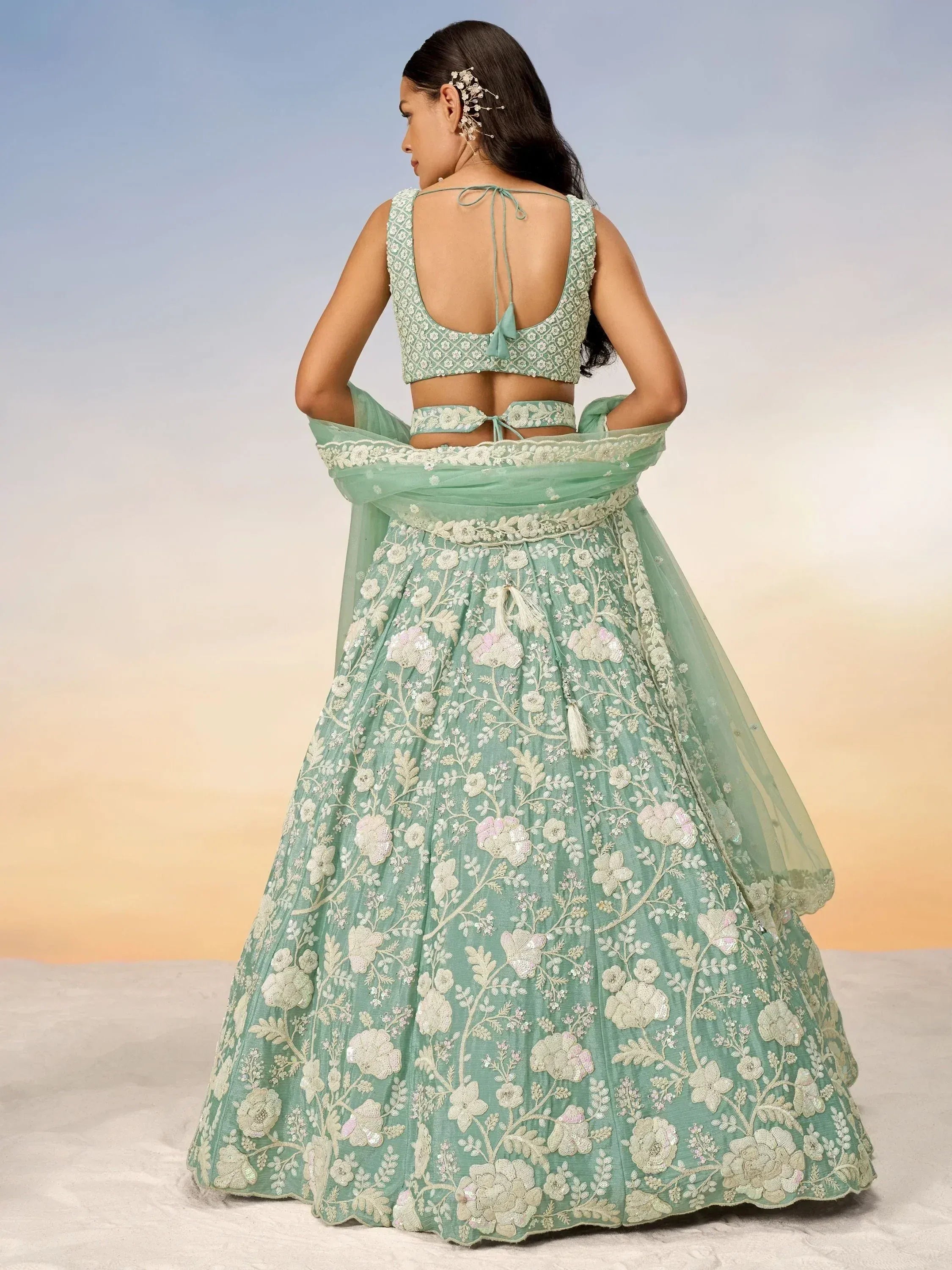 Mint green designer lehenga choli with floral embroidery, perfect for Indian weddings and festive occasions.