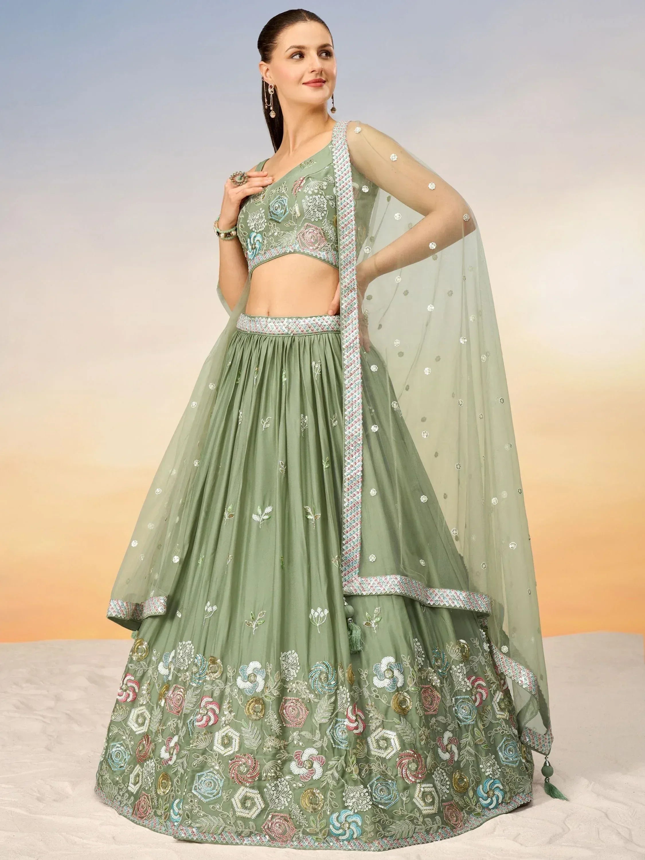 Sage green embroidered lehenga choli with floral motifs and sheer dupatta, perfect for Indian ethnic occasions
