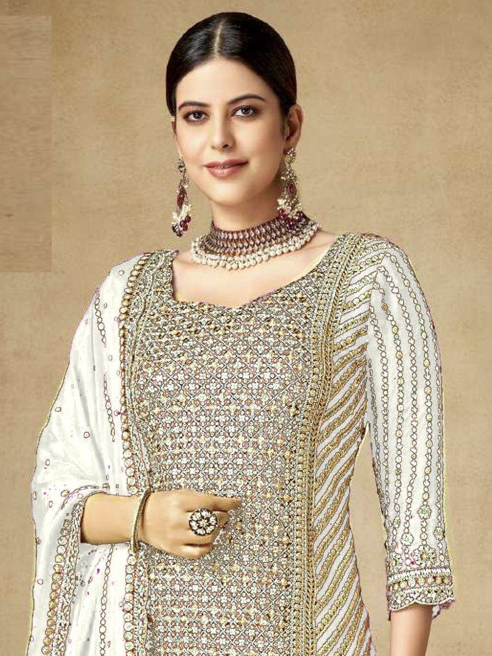Elegant Indian ethnic wear with intricate embroidery and jewelry, perfect for festive occasions.
