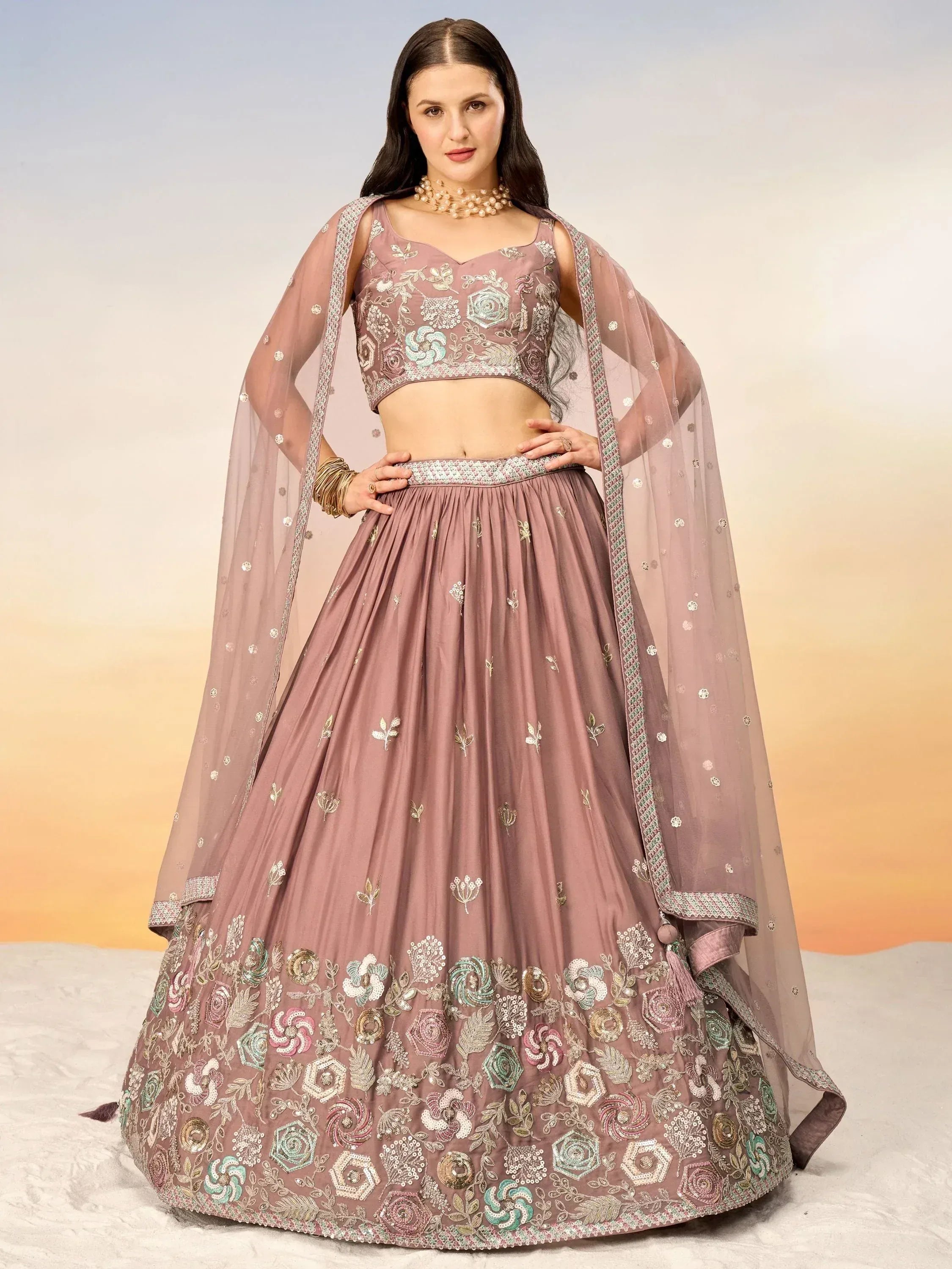 Dusty pink embroidered lehenga choli with floral motifs and sheer dupatta, perfect for Indian ethnic wear.