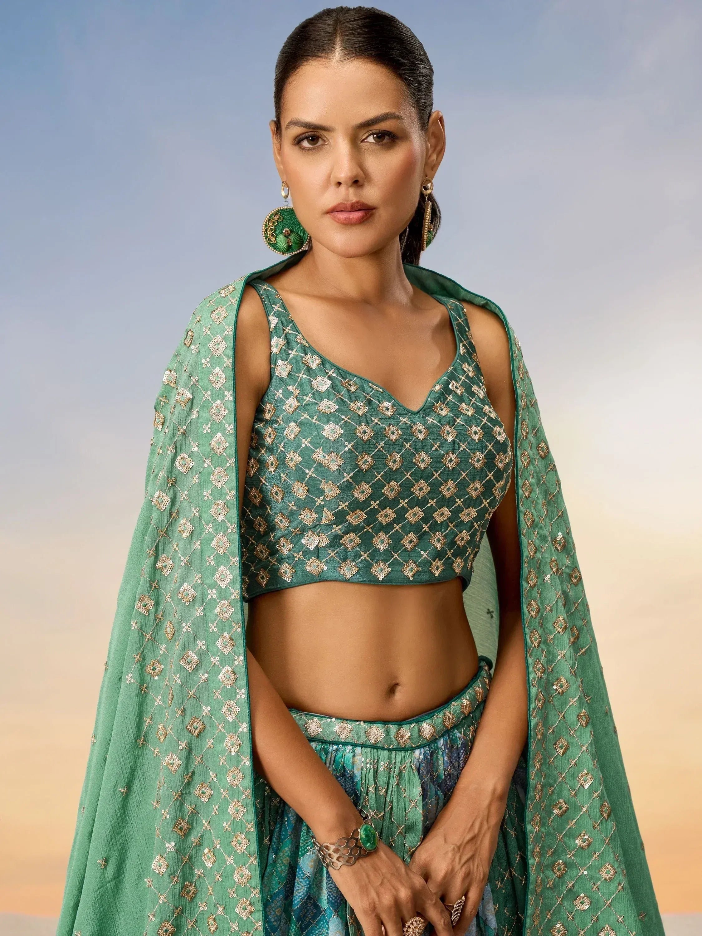 Emerald green embroidered lehenga choli with matching dupatta, perfect for Indian ethnic wear occasions.