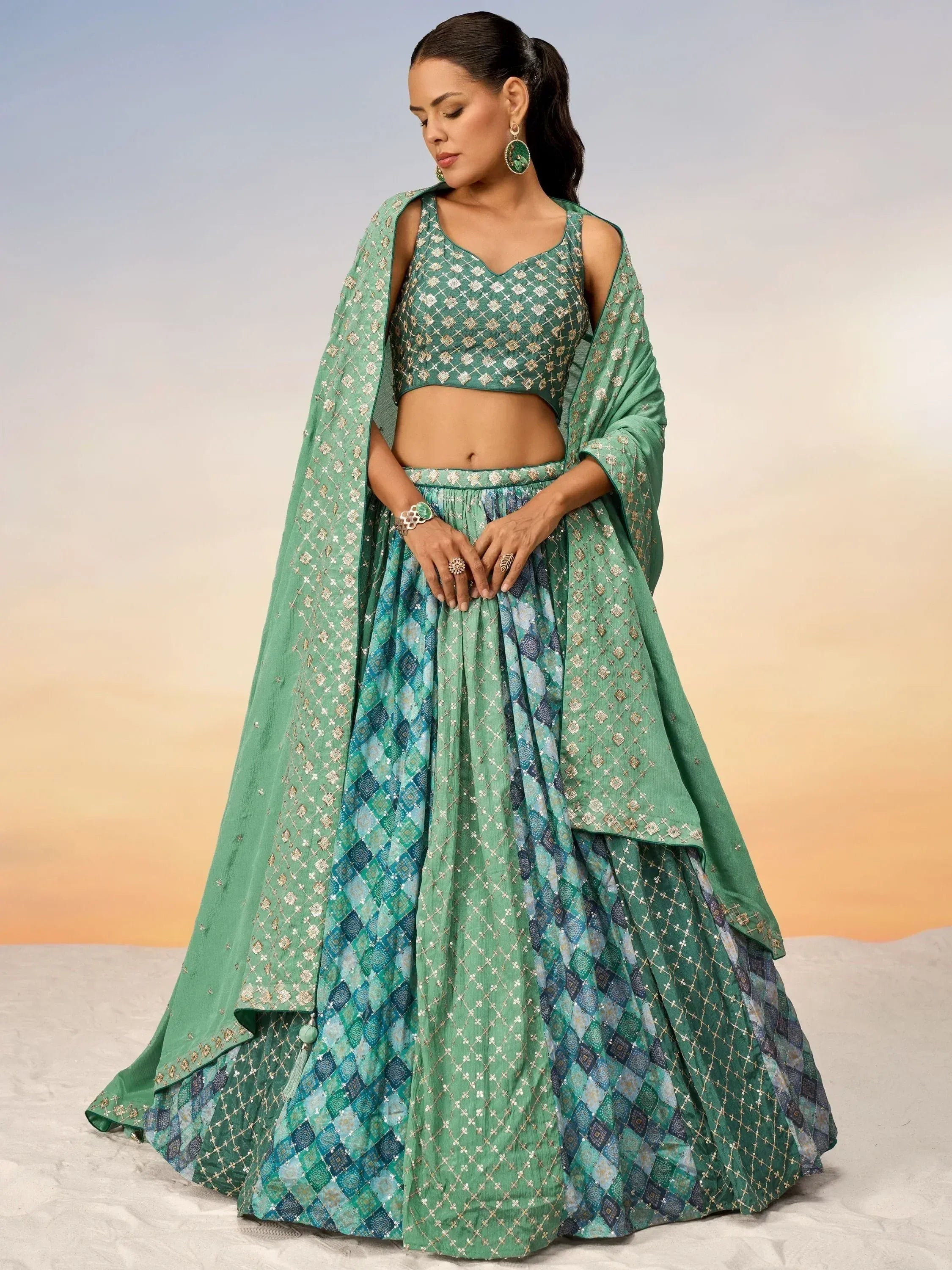 Green embroidered lehenga choli with geometric patterns and matching dupatta for ethnic wear