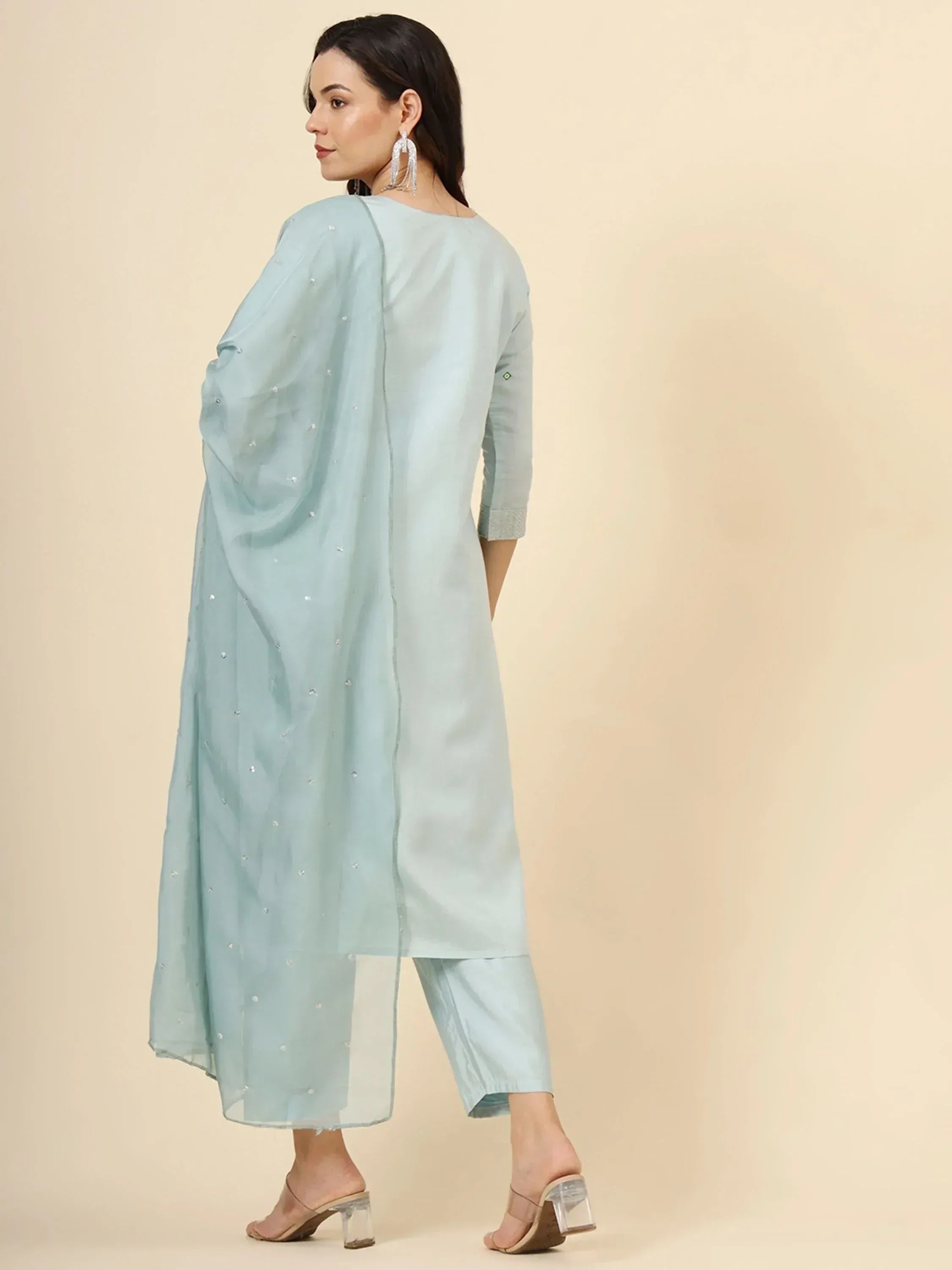 Light blue ethnic kurta with sheer dupatta and embellishments, paired with matching pants and heels