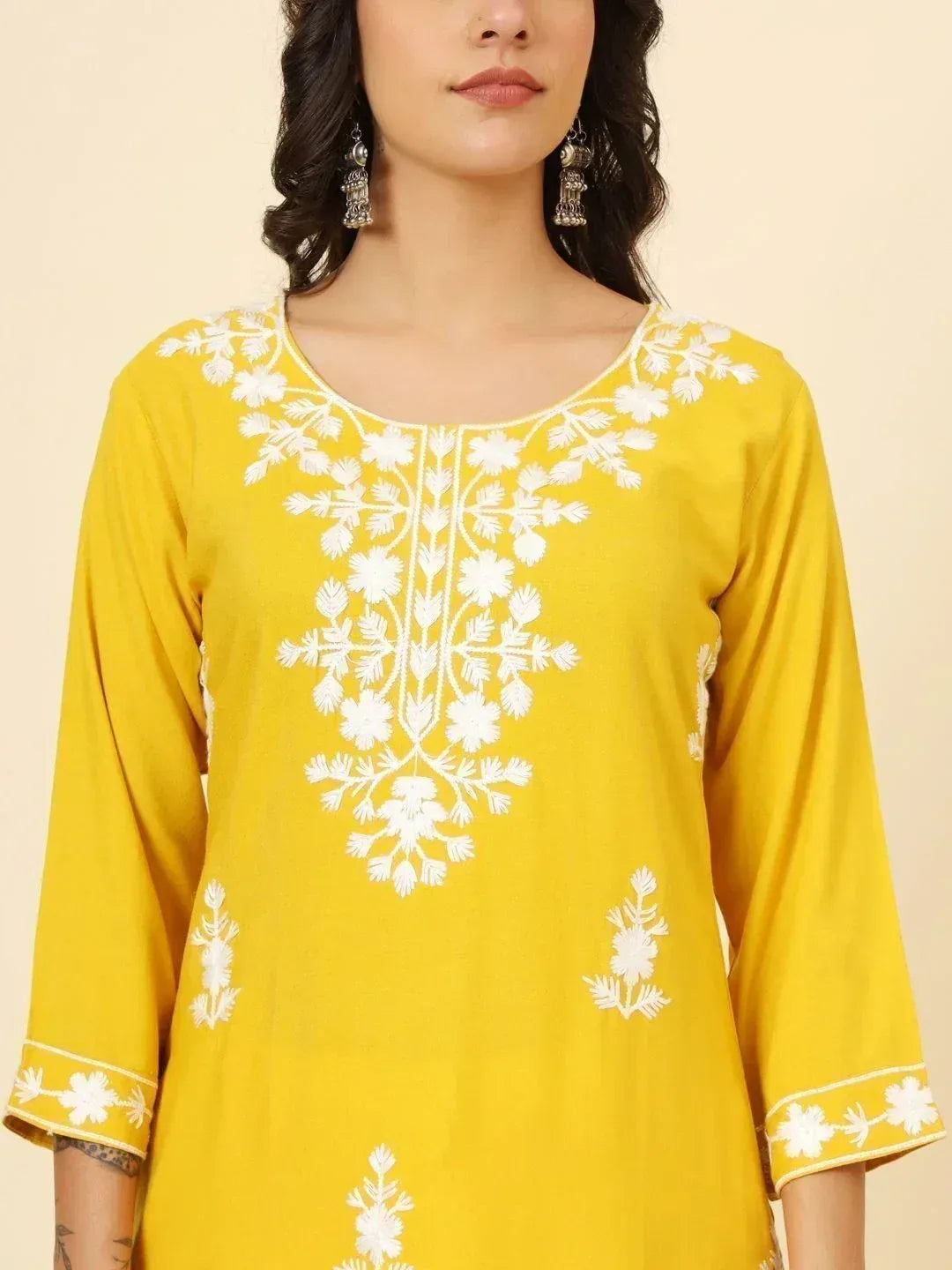 Yellow ethnic kurti with white floral embroidery, perfect for Indian wear and festive occasions.