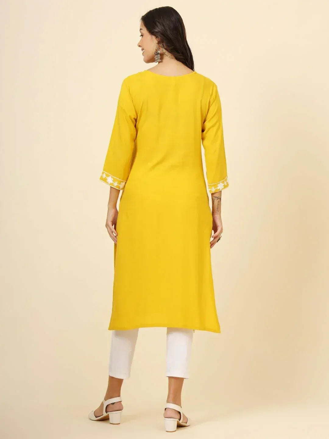 Yellow ethnic kurta with white floral embroidery on sleeves, paired with white pants for women