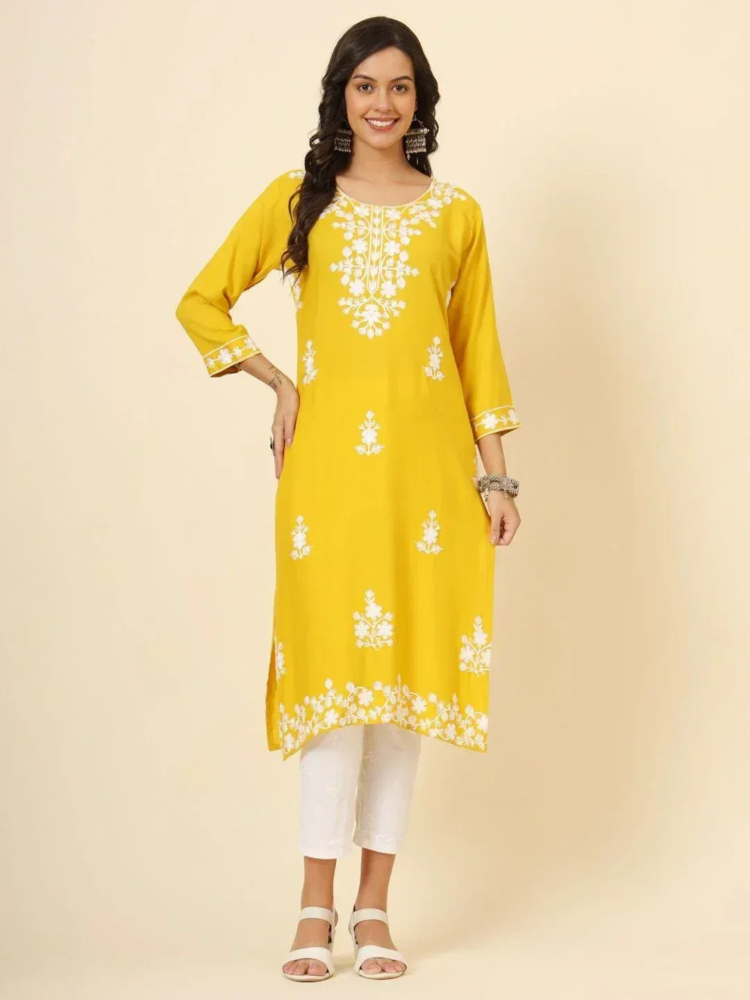 Yellow embroidered kurta with white floral print, paired with white pants for ethnic wear